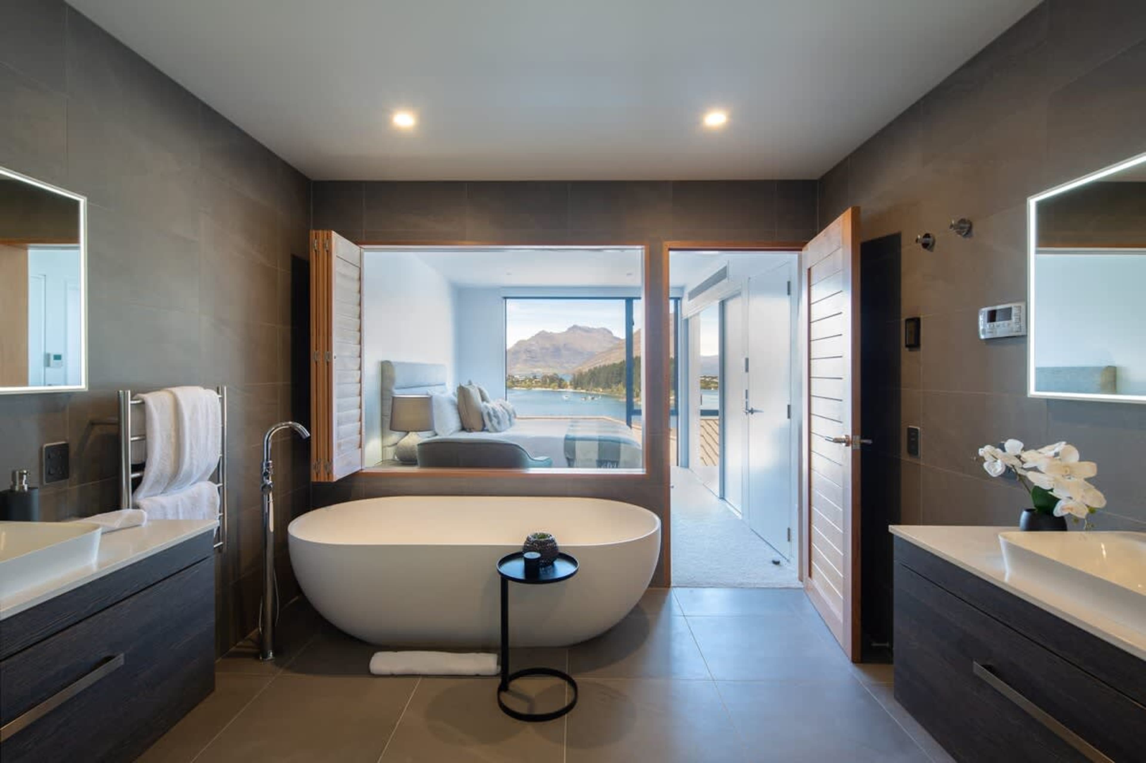 Master Bathroom - Luxurious Comfort
Indulge in the master bathroom featuring heated floors, a relaxing spa bath, and premium Ashley & Co. toiletries for a touch of luxury.