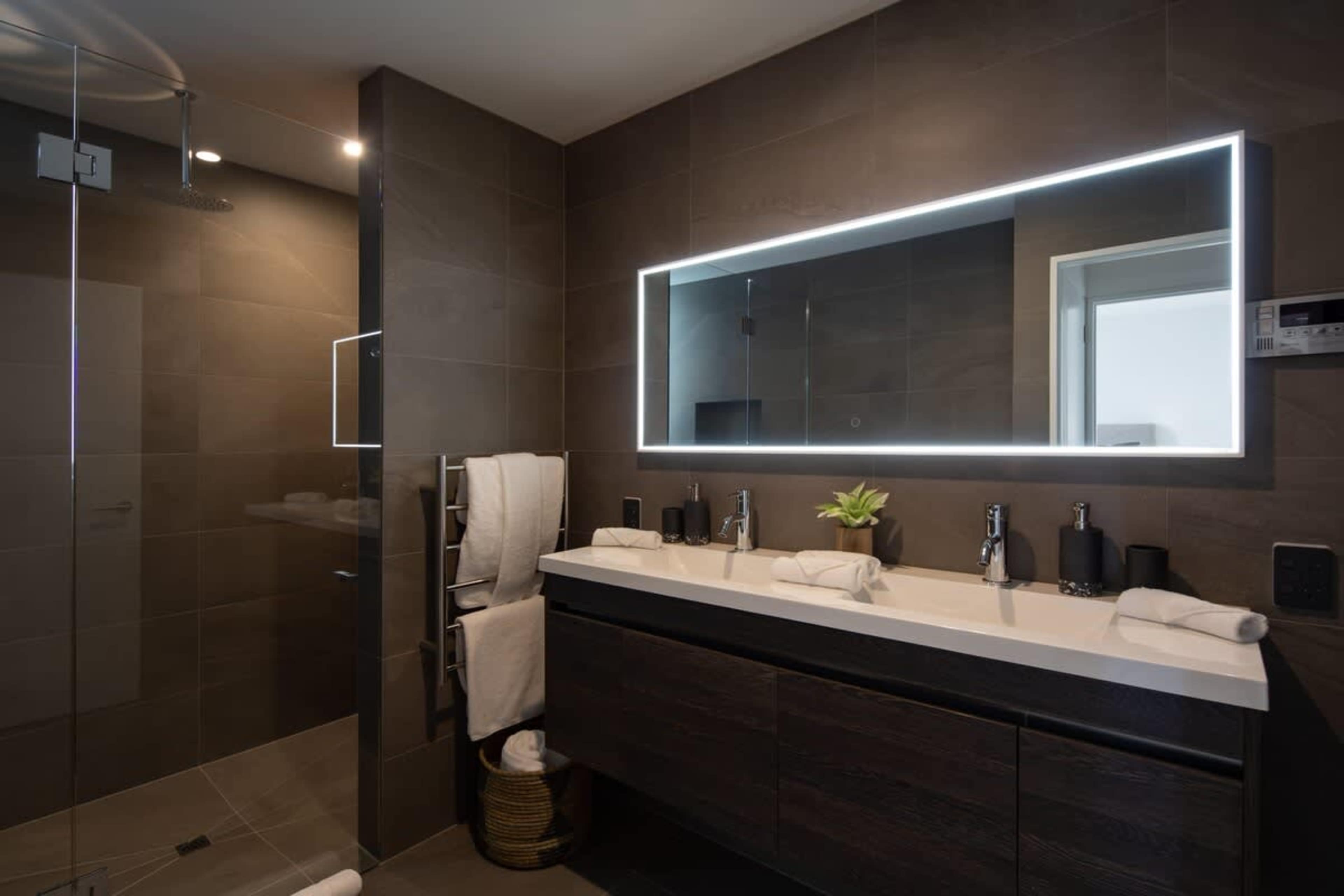 Master Bathroom - Spa-Like Experience
Unwind in the master bathroom with heated floors, a luxurious spa bath, and Ashley & Co. toiletries for a true retreat experience.