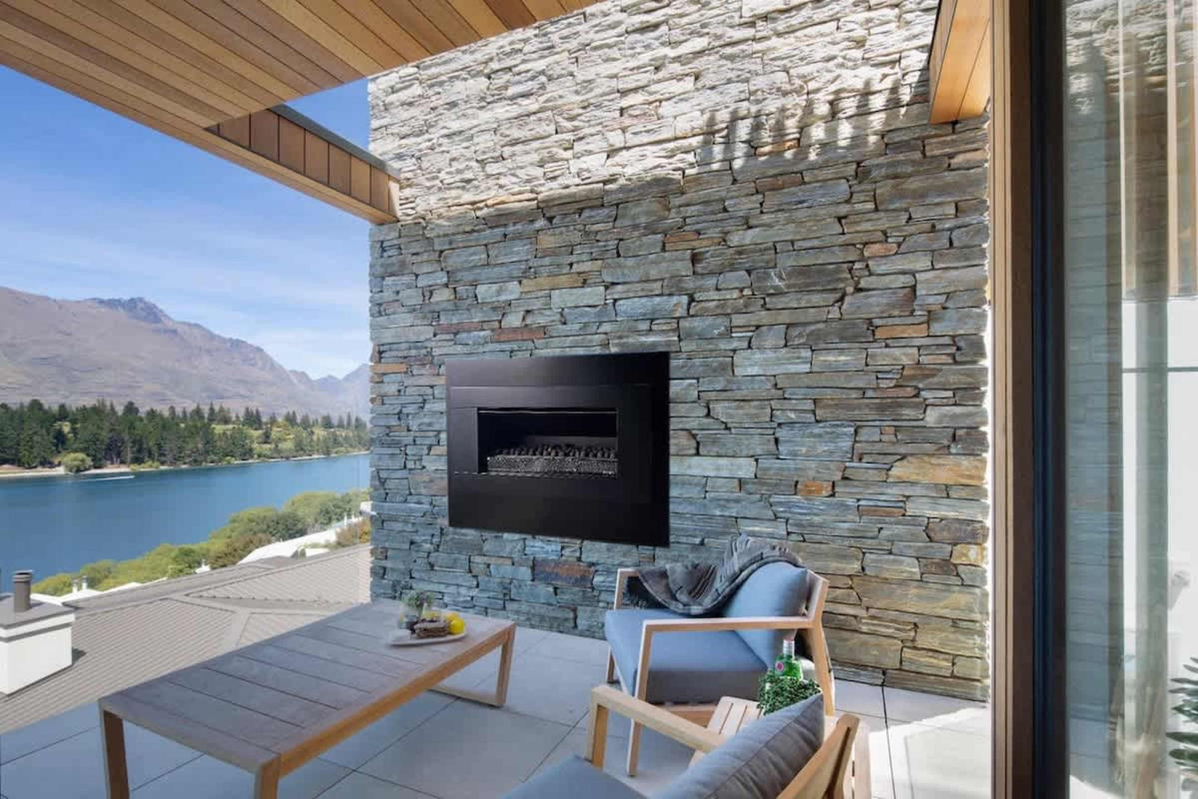 Patio - Luxury Outdoors
Unwind on the patio with panoramic views and a stylish fireplace, blending comfort with nature.