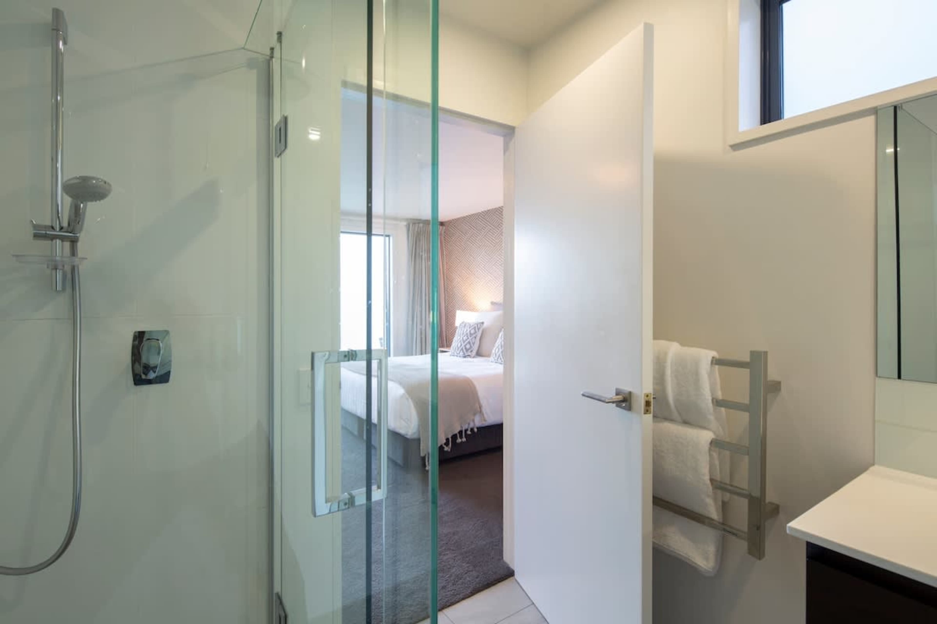 Luxurious Ensuite Retreat: Indulge in the master ensuite with heated floors, a sleek walk-in shower, and Ashley & Co toiletries. Warm towel rails add a touch of spa-like comfort.