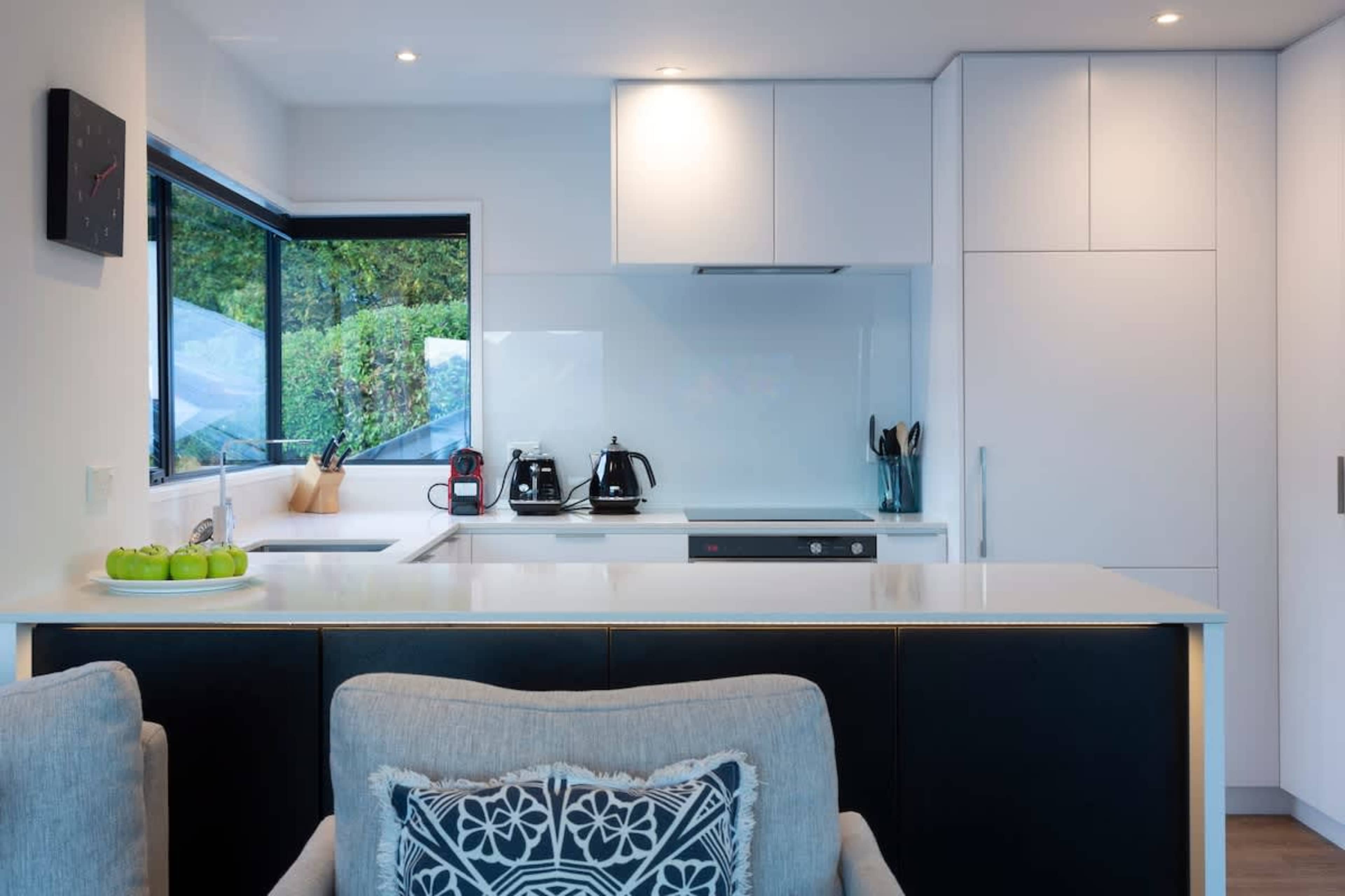 Stylish and Functional: Cook in style with this modern kitchen, complete with a Nespresso machine, quality appliances, and everything needed for dining in with ease.