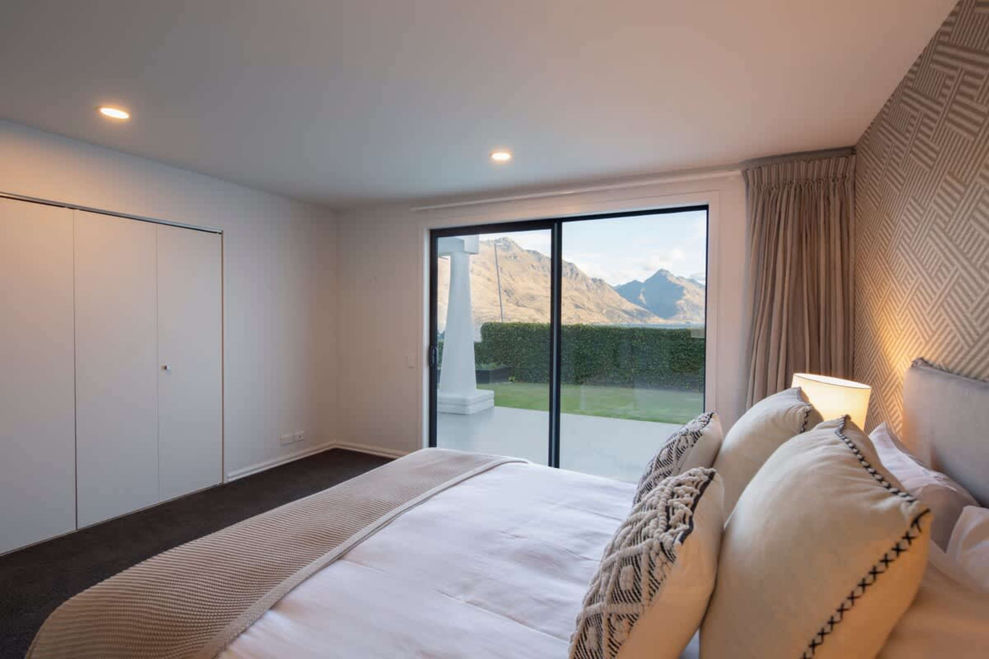 Private and Tranquil: Relax in the second bedroom, featuring comfortable bedding and direct access to a secluded courtyard for quiet moments outdoors.