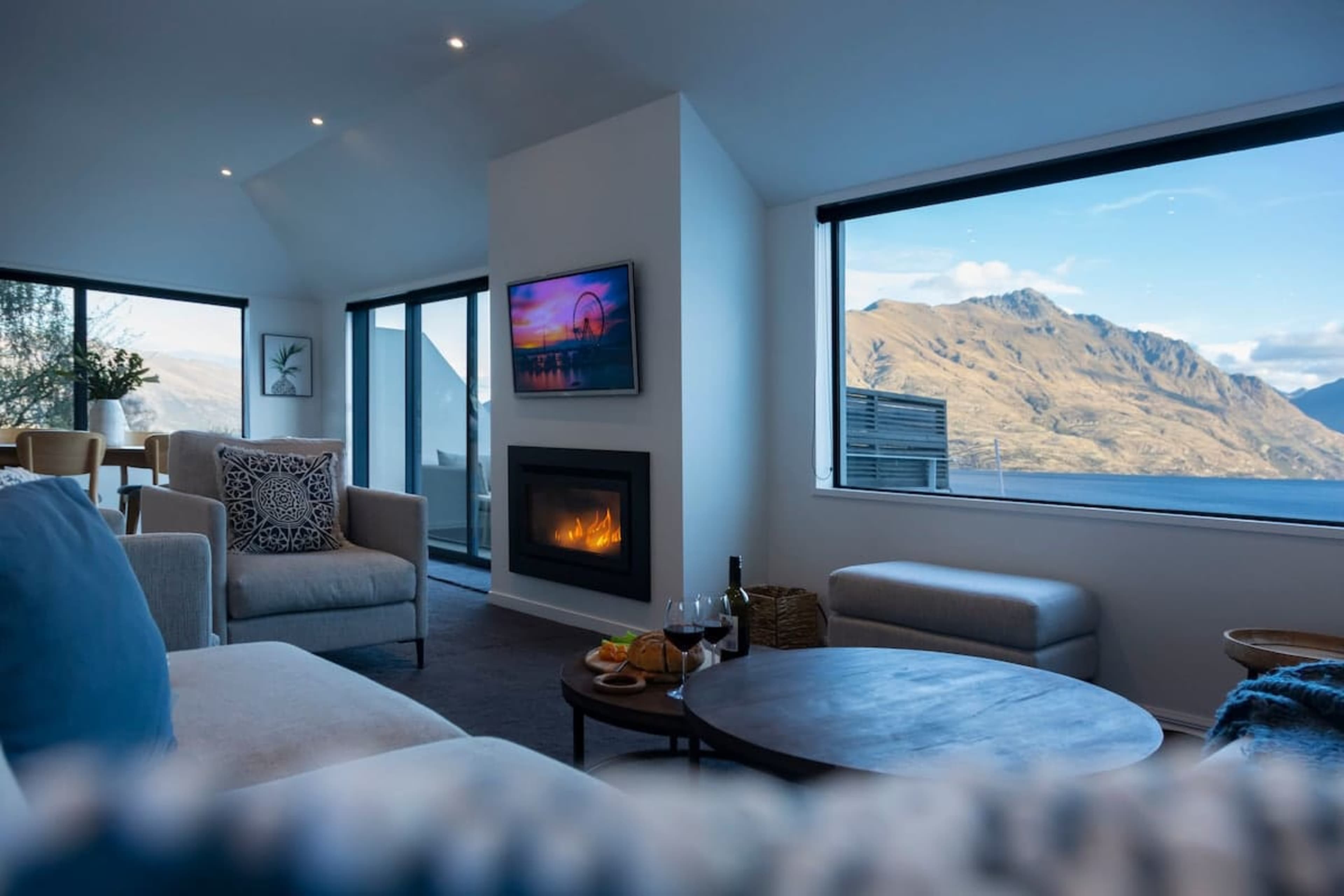Bright and Airy Living Room: Relax in this spacious living area with stunning Queenstown Hill views, a cozy gas fireplace, AC for comfort year-round, and plenty of room for family fun.
NZ luxury travel