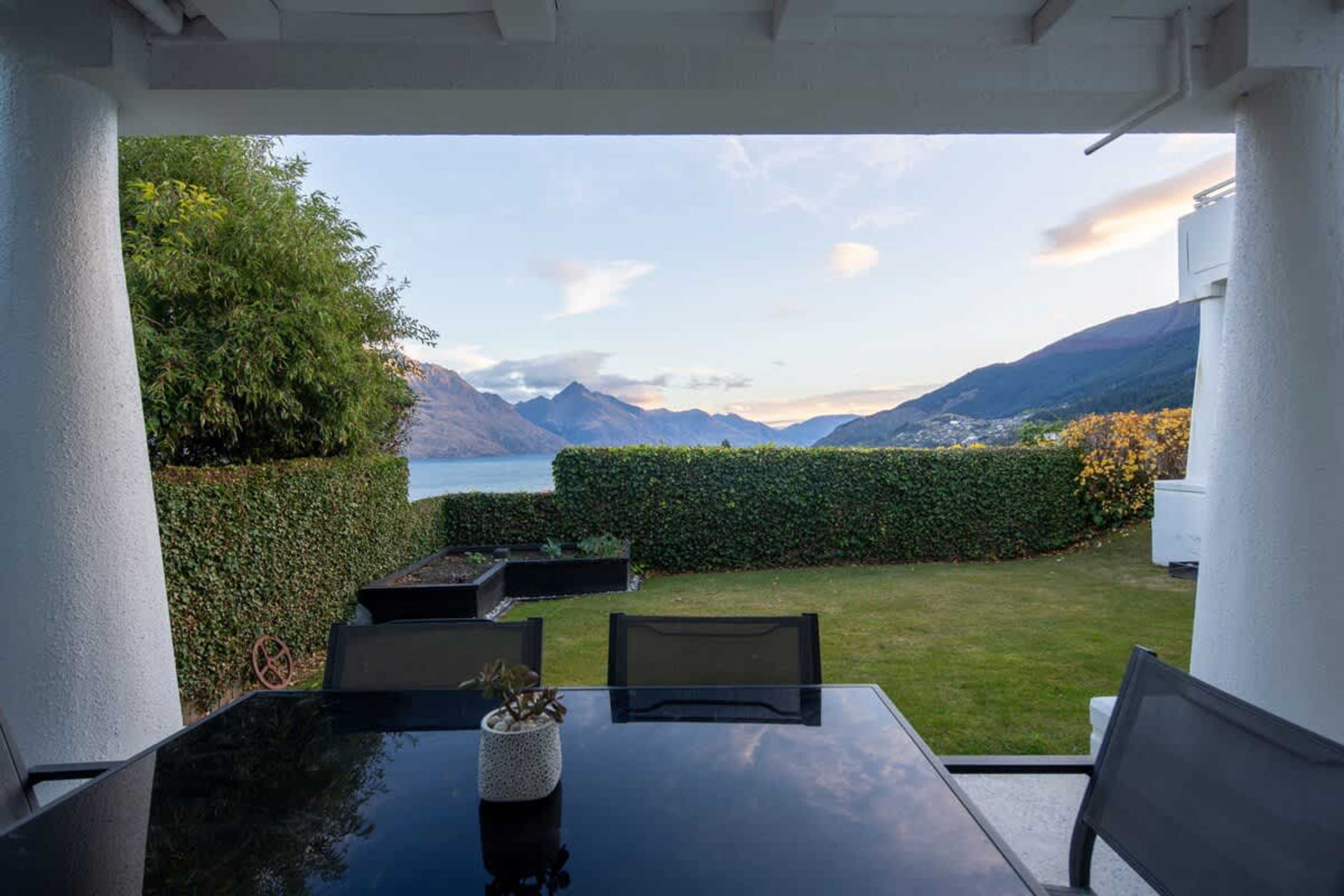 Tranquil Escape: This charming patio offers a peaceful outdoor retreat with comfortable seating and a serene garden setting.