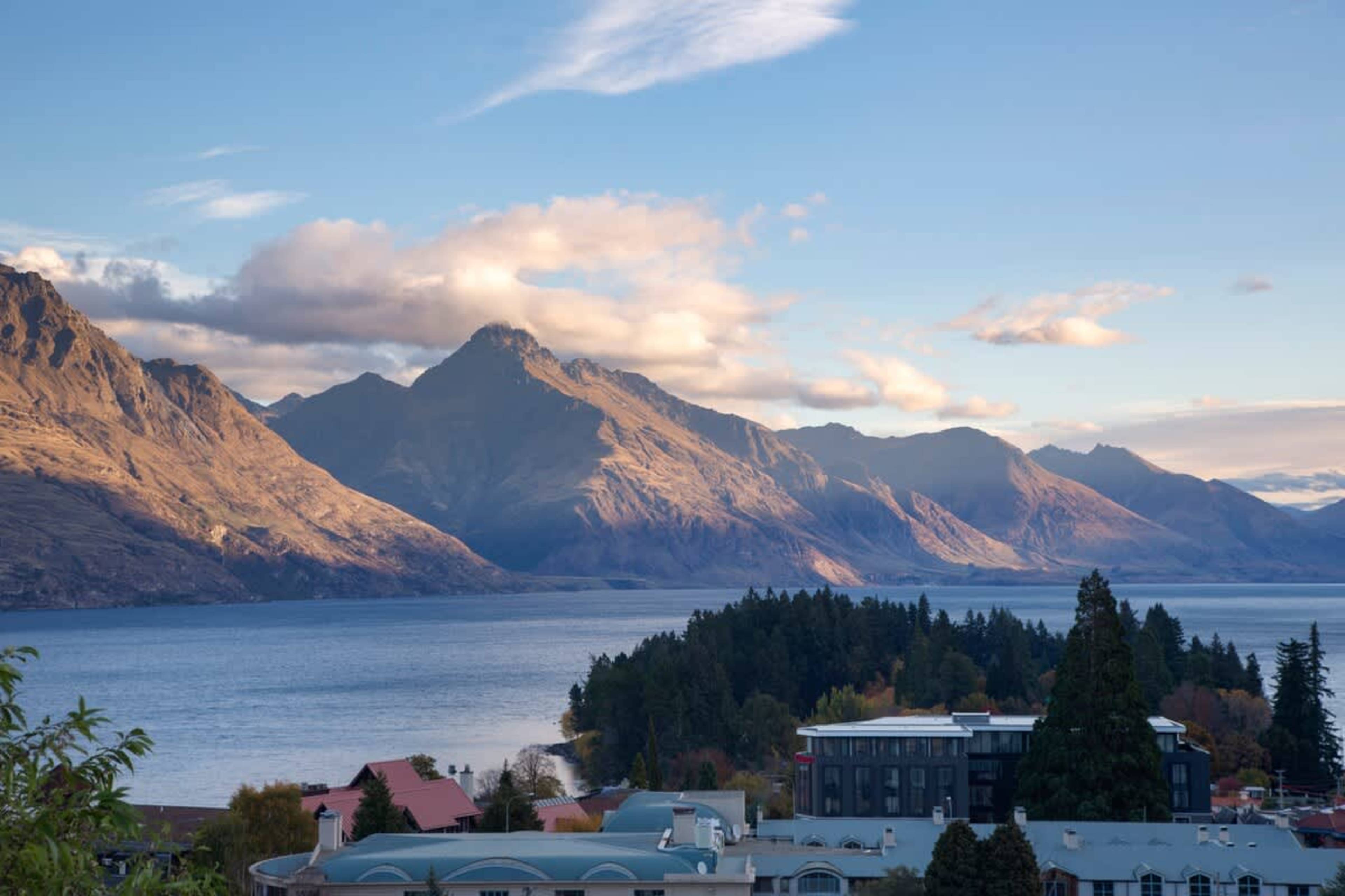 Alfresco Perfection: This spacious balcony offers a BBQ, comfortable seating, and uninterrupted views, perfect for dining outdoors or soaking in the Queenstown scenery.