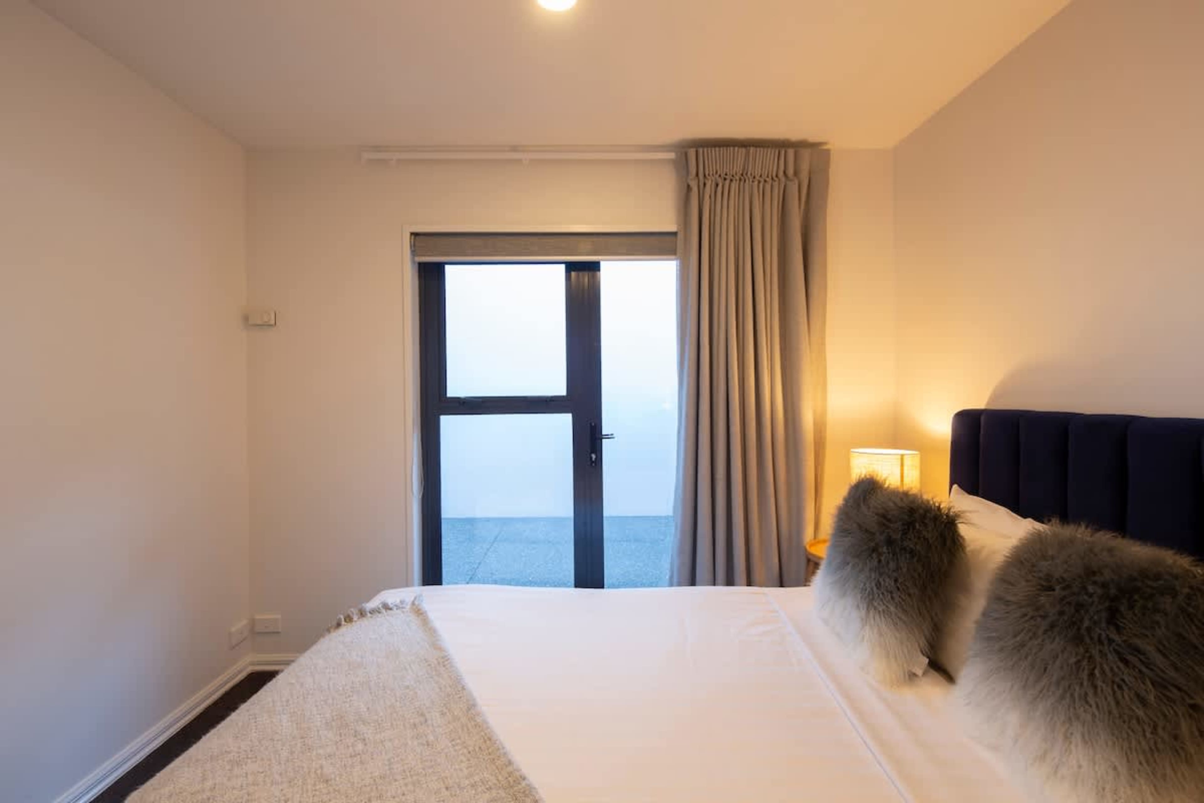 Comfortable and Versatile: The third bedroom offers a serene space with plush linens and stylish touches, ideal for a restful stay.