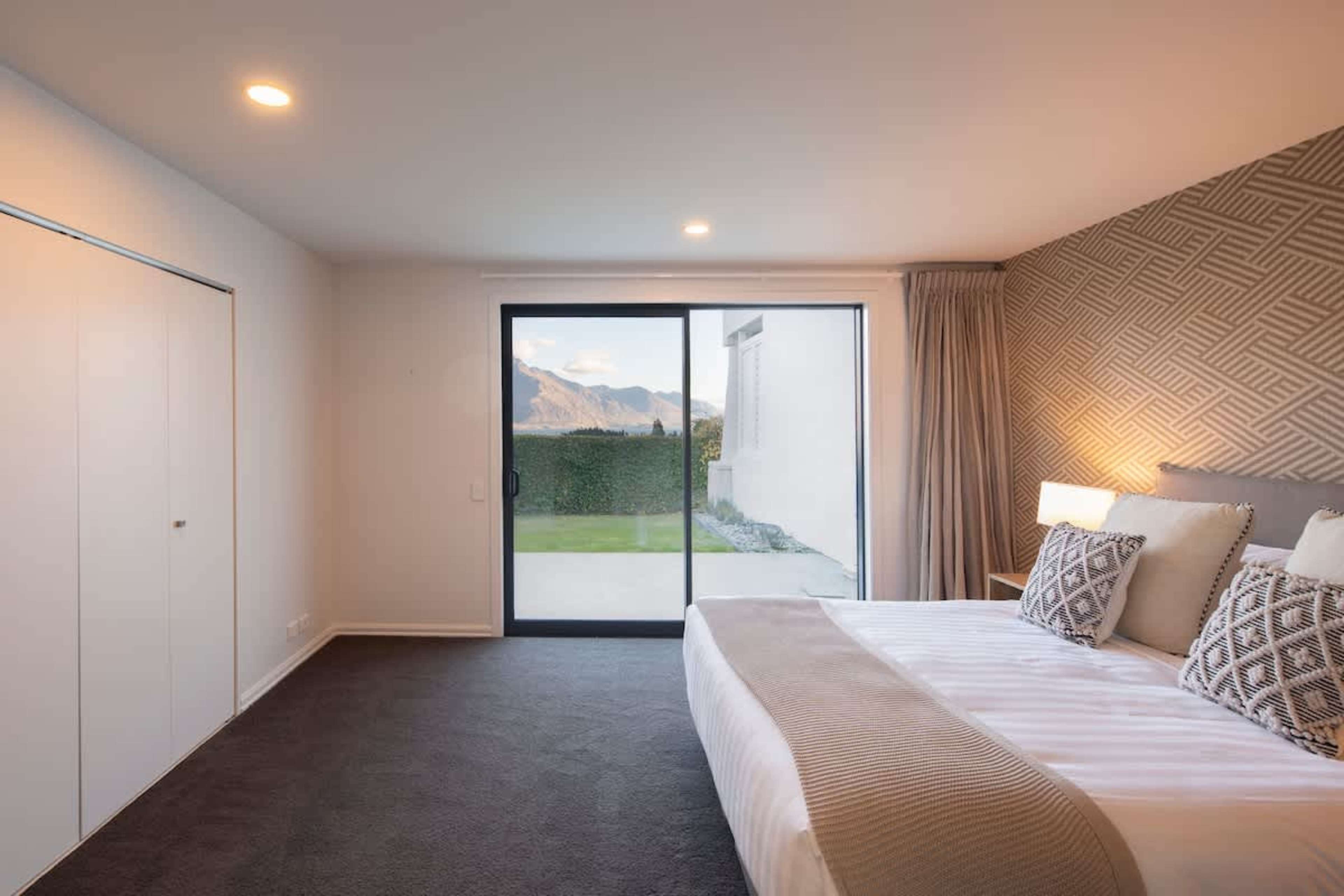 Serene Second Bedroom: Cozy and inviting, this second bedroom opens to a private courtyard, offering a peaceful retreat with fresh air and a touch of nature.