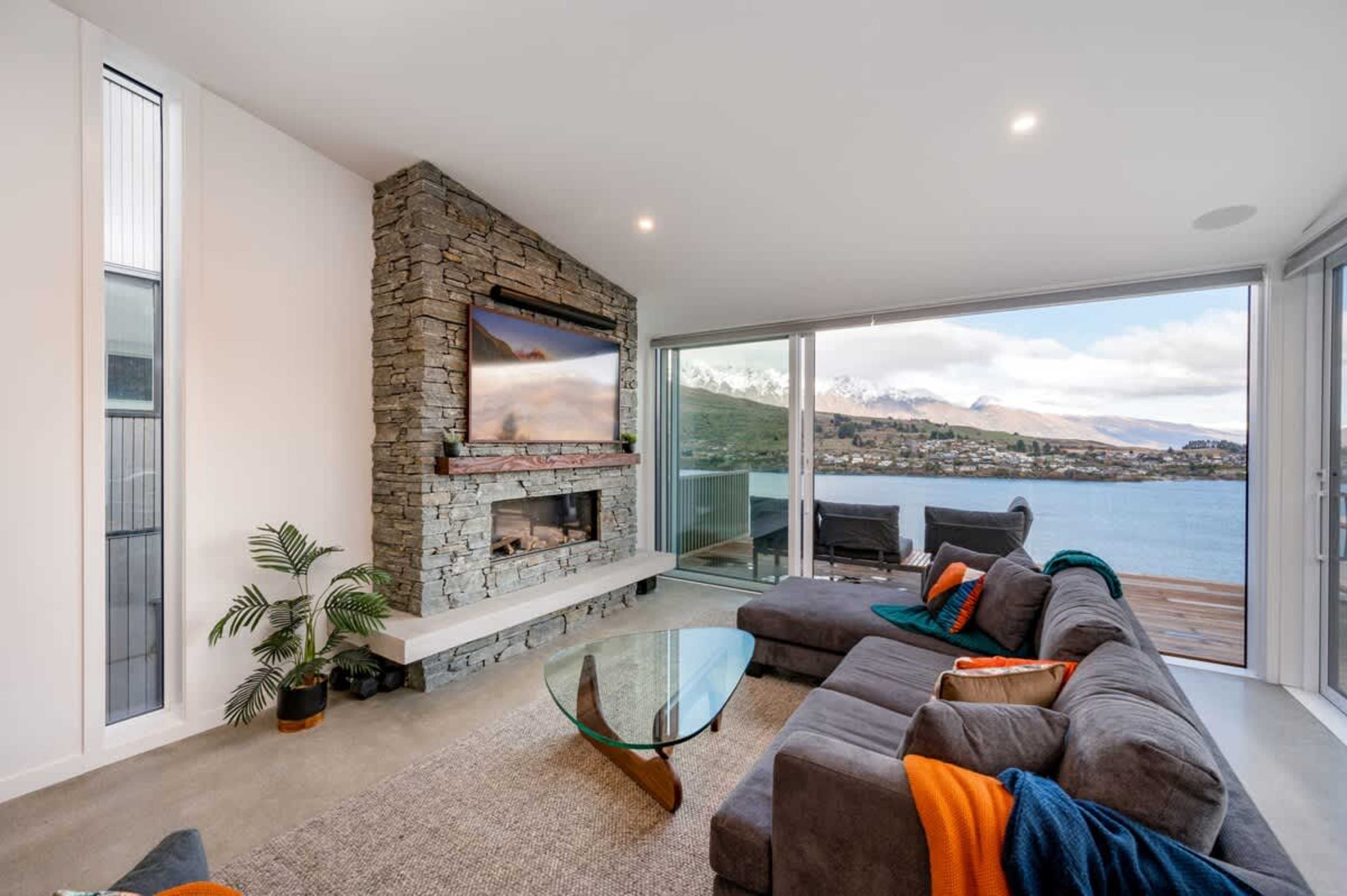 With a luxurious gas fireplace, comfortable seating, and expansive windows offering breathtaking views, the living room provides an inviting space to enjoy both the scenery and great company.