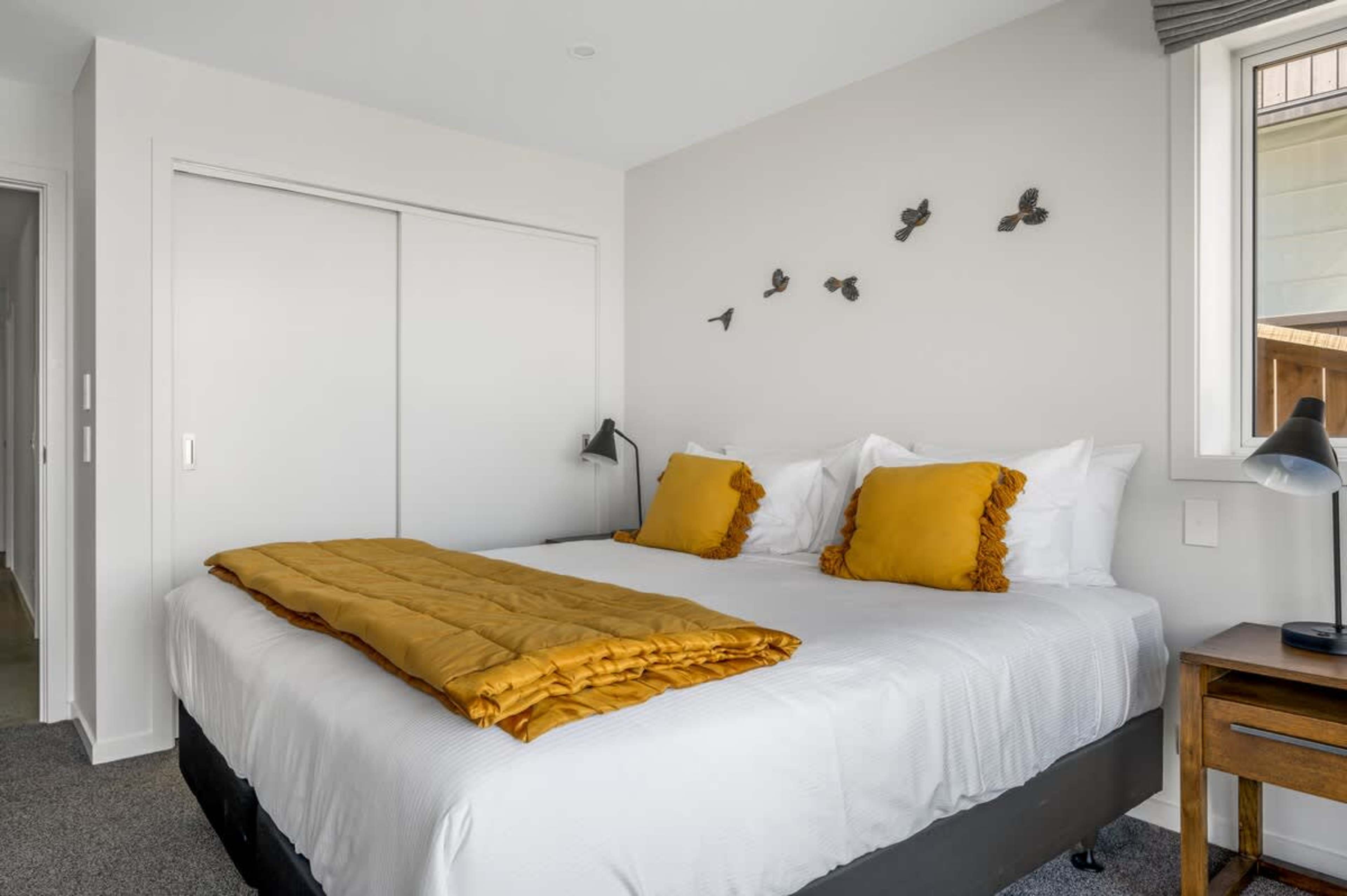 This cozy second bedroom is furnished with a king-sized bed, modern furnishings, and tranquil views, providing a serene atmosphere for relaxation after a day of adventure.