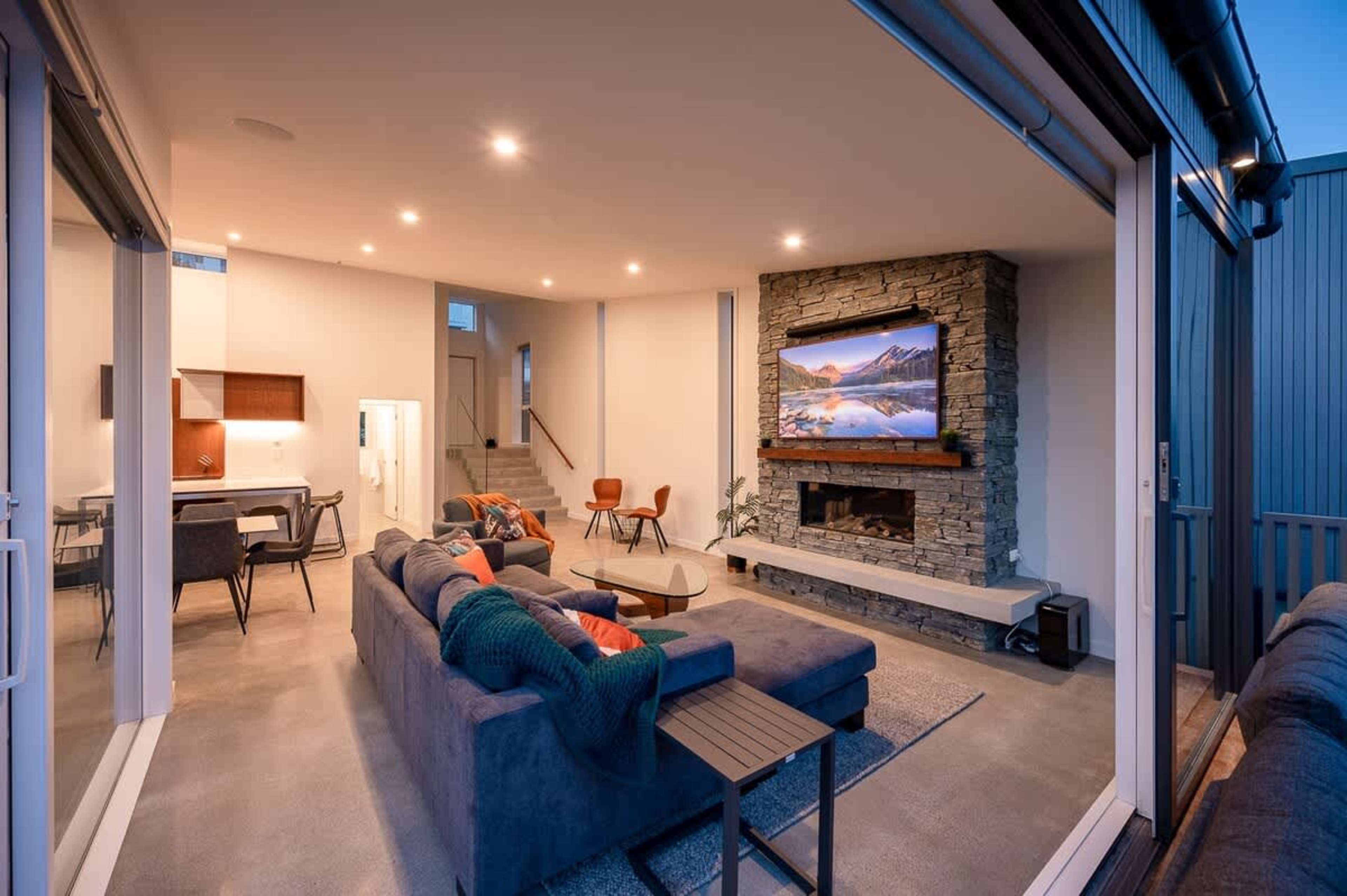 Relax in the expansive living room, complete with a cozy gas fireplace, elegant furnishings, and floor-to-ceiling windows that frame stunning views of the lake and mountains.
NZ luxury travel