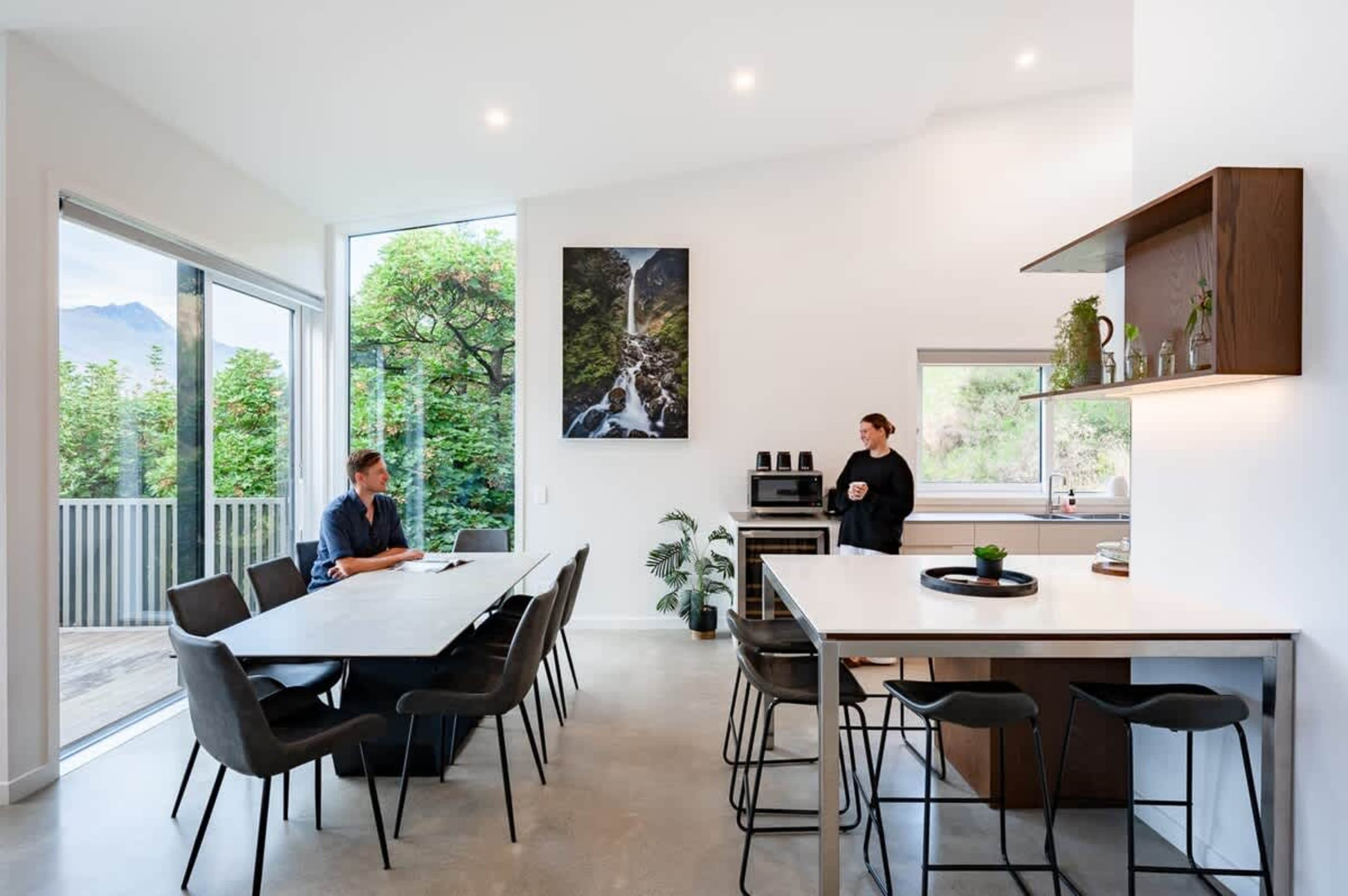 With premium appliances, a wine fridge, and a coffee machine, this newly refurbished kitchen flows effortlessly to the outdoor deck, offering stunning views and creating an ideal space for cooking and entertaining.
