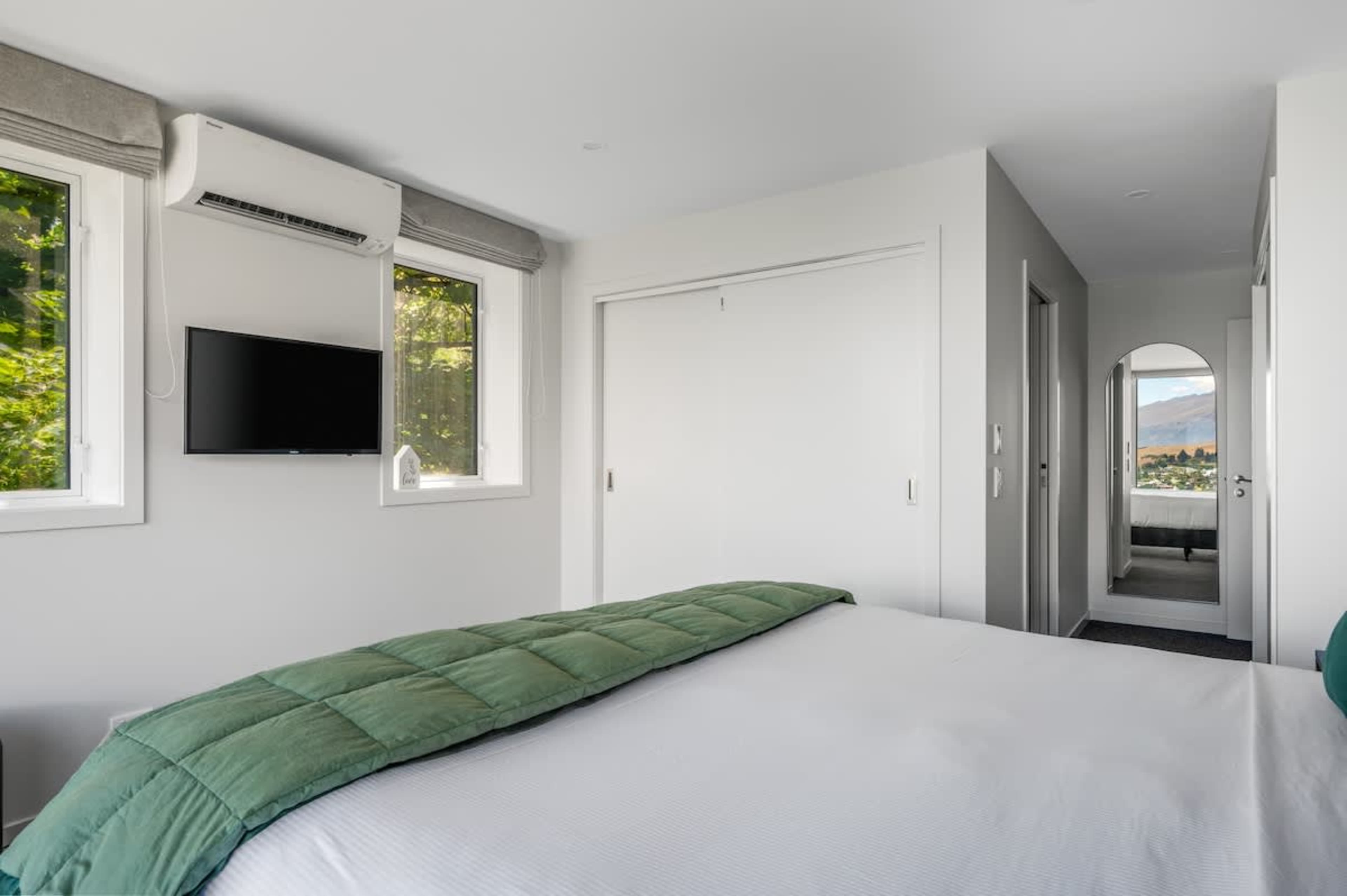 With a spacious king-sized bed, a stylish ensuite, and panoramic views of the lake and mountains, the master bedroom offers the perfect blend of comfort and luxury.