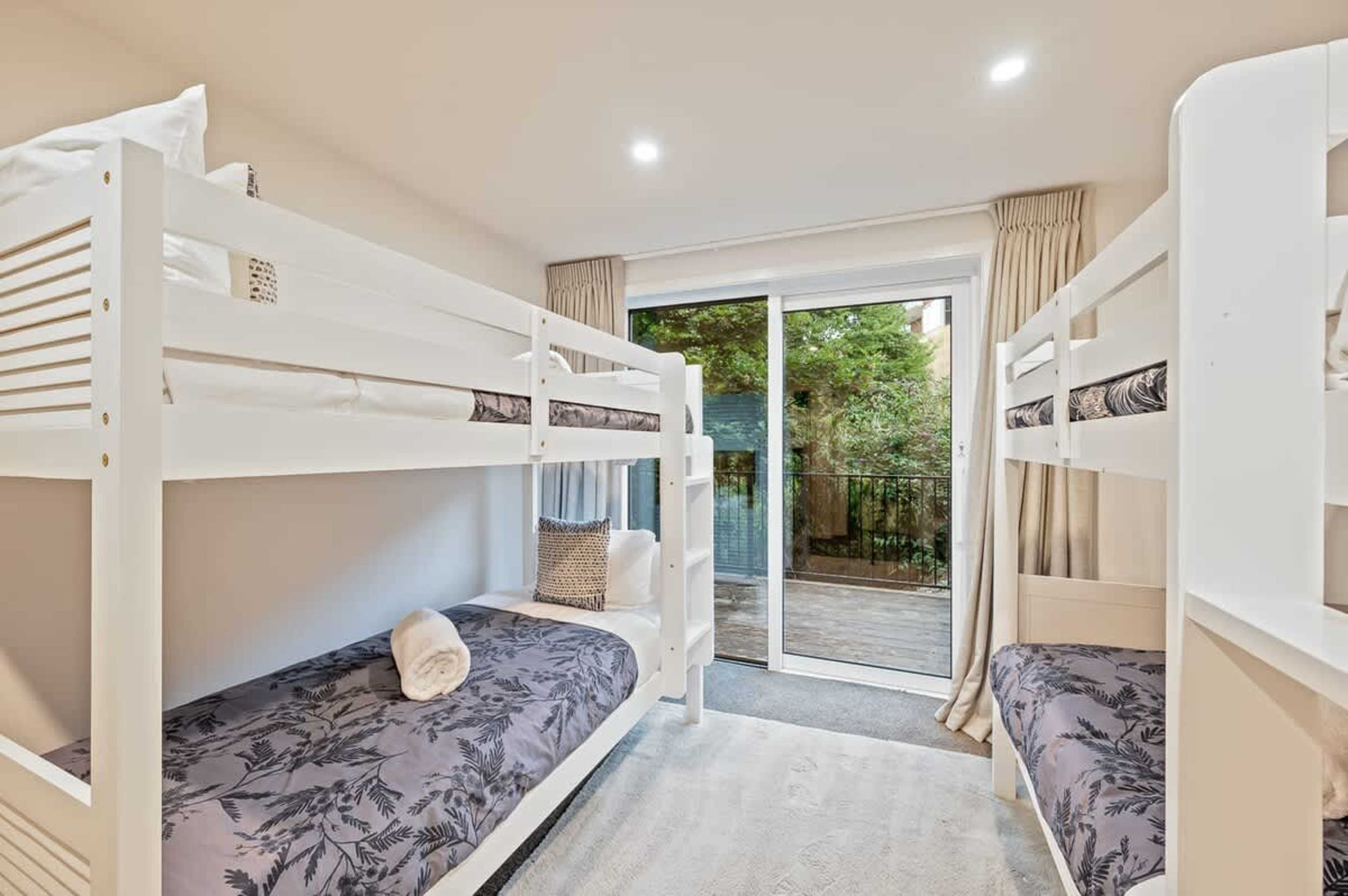 This family-friendly fourth bedroom is equipped with four bunk beds, offering plenty of space for kids to sleep comfortably, making it the perfect room for a fun and cozy stay.