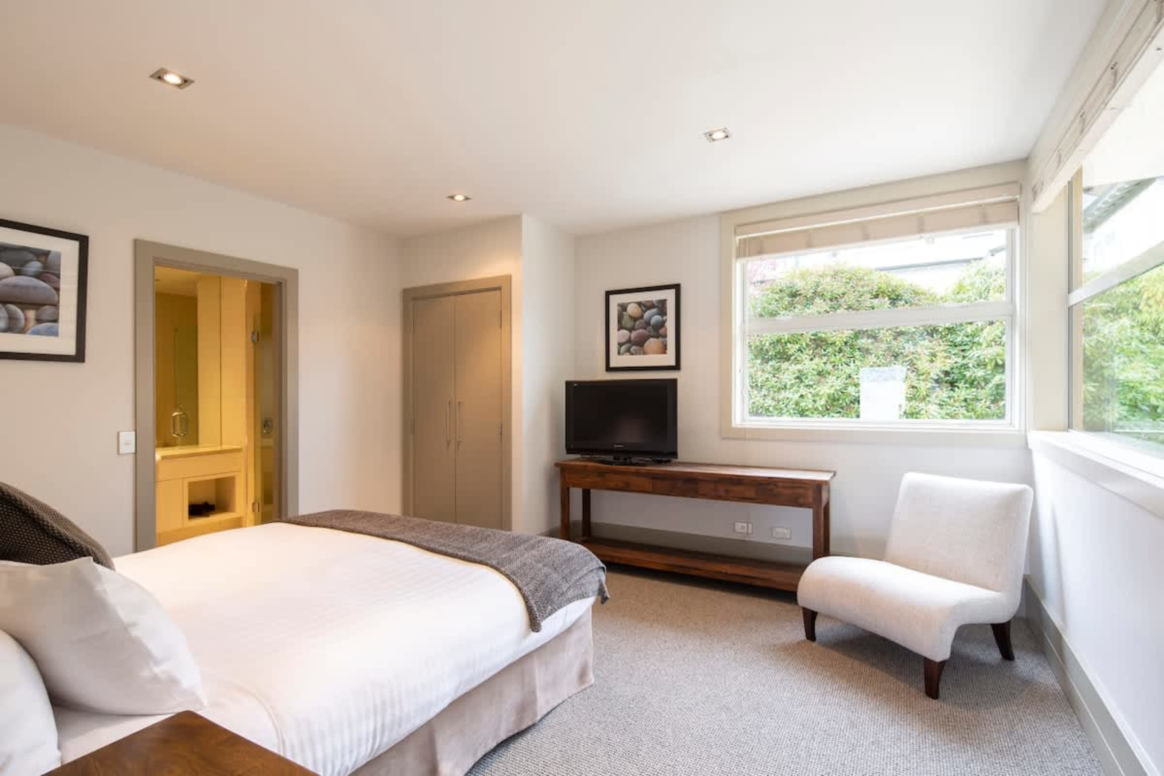 Elegant Master Suite: Spacious master bedroom with a luxurious king bed, ensuite bathroom, and stunning lake views. A serene retreat for ultimate relaxation.