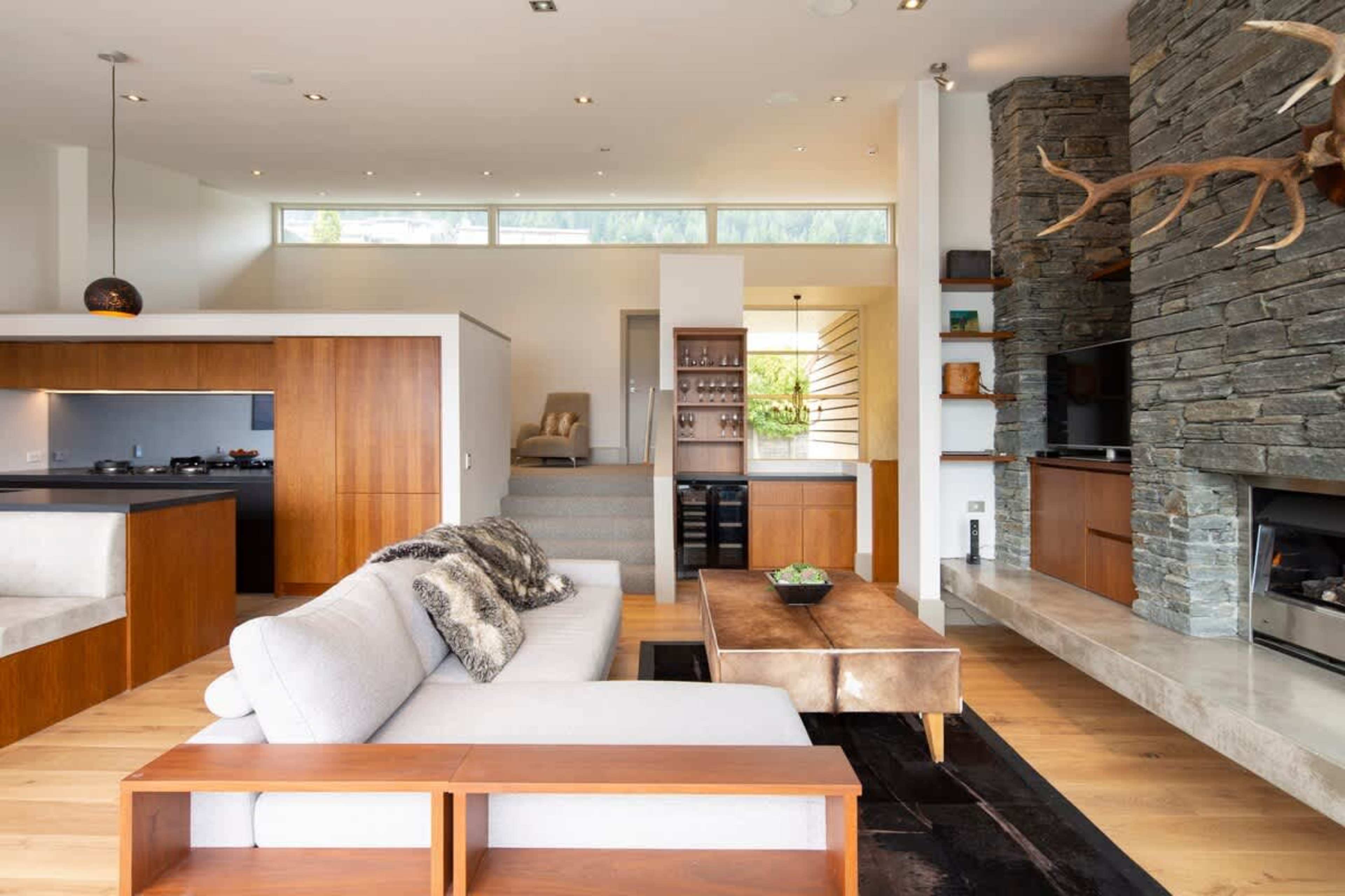 Relax and Unwind: Gather with loved ones in the living room featuring a gas fireplace and luxurious decor, all within walking distance to Queenstown.
Luxury accommodation New Zealand