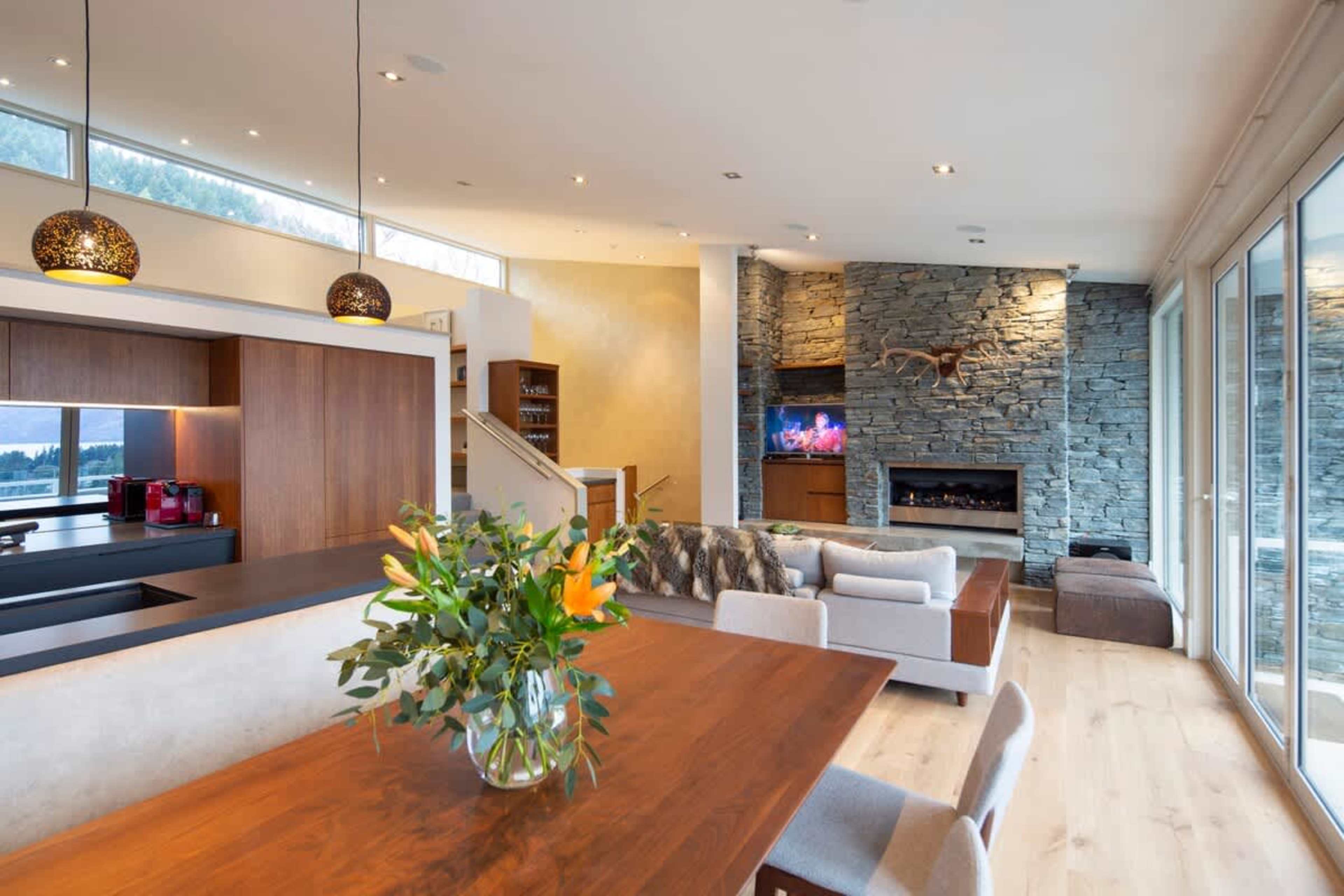 Dine with a View: Elegant dining area with a stylish table and seating for six, perfectly positioned to enjoy panoramic lake and mountain views.