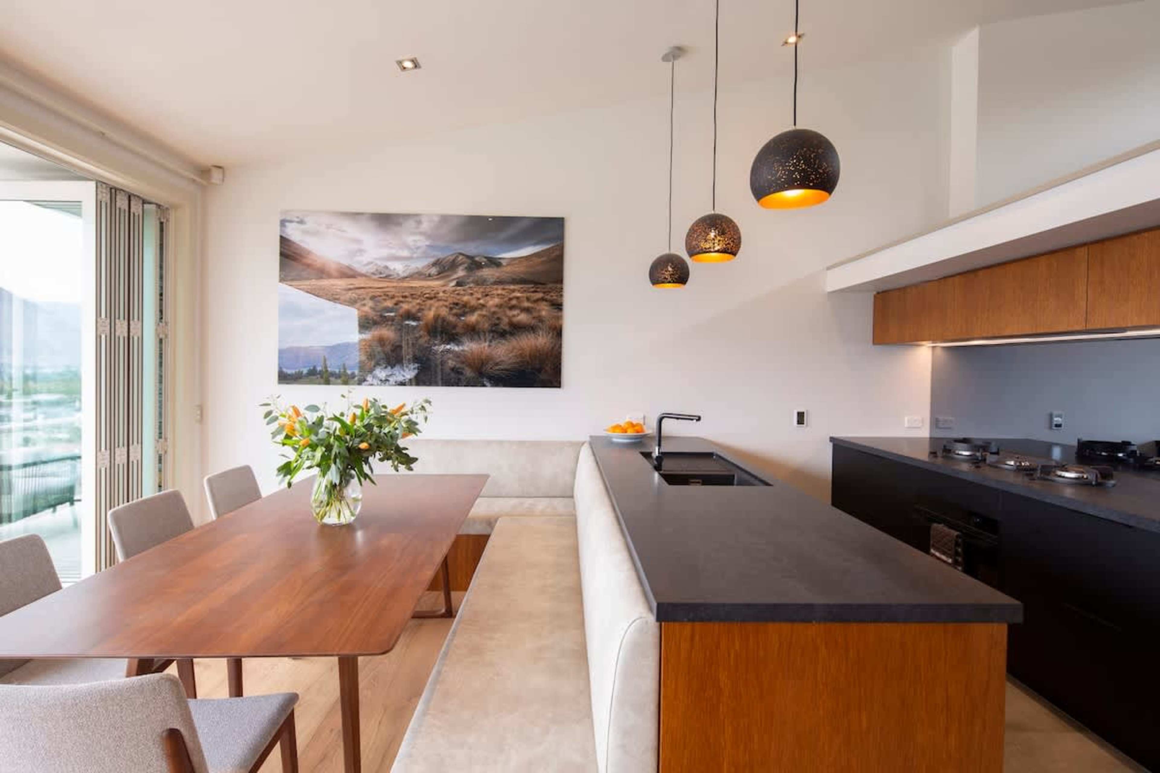 Cook with a View: Modern kitchen boasting sleek appliances and stunning lake and mountain views, perfect for preparing meals in a breathtaking setting.
Queenstown, NZ