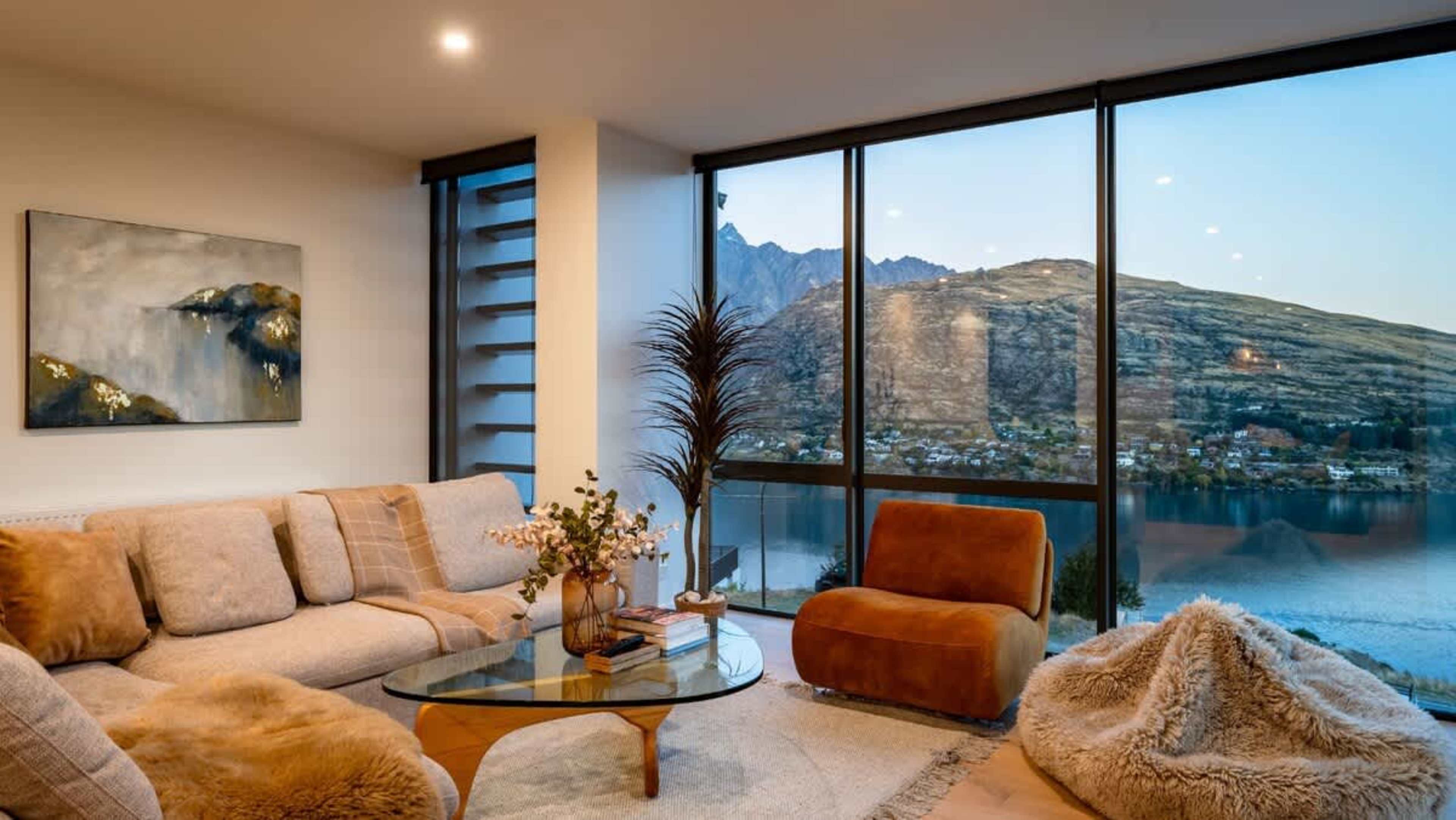 Step into the sophisticated living room of this stunning 4-bedroom villa, complete with a cozy indoor fireplace, heated floors, and panoramic views of Lake Wakatipu and the Remarkables.
Indulge in relaxation at our luxury accommodation, New Zealand