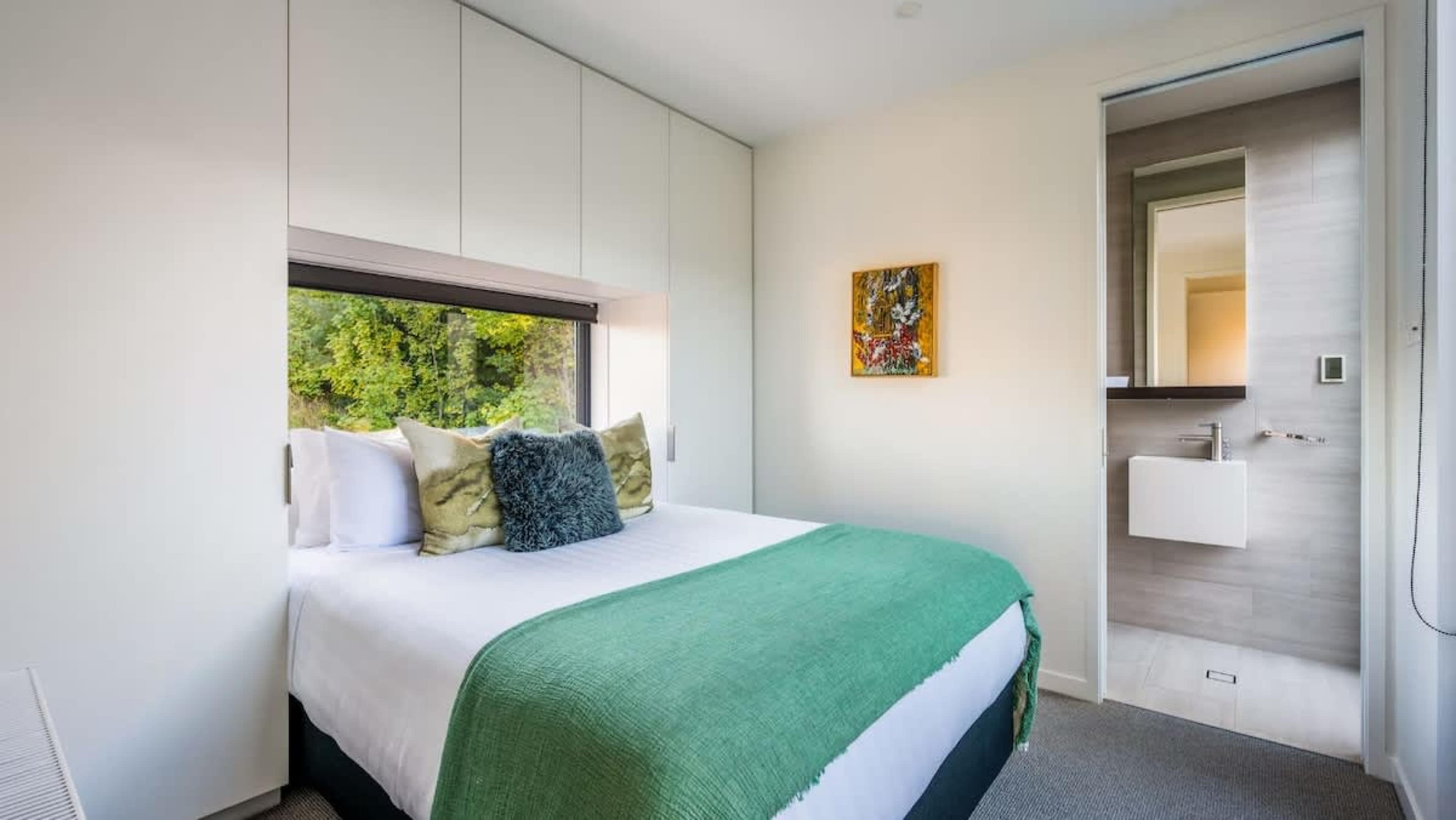 The fourth bedroom offers a luxurious king-sized bed, a private ensuite with modern fixtures, and a peaceful ambiance, making it the perfect retreat for ultimate relaxation.