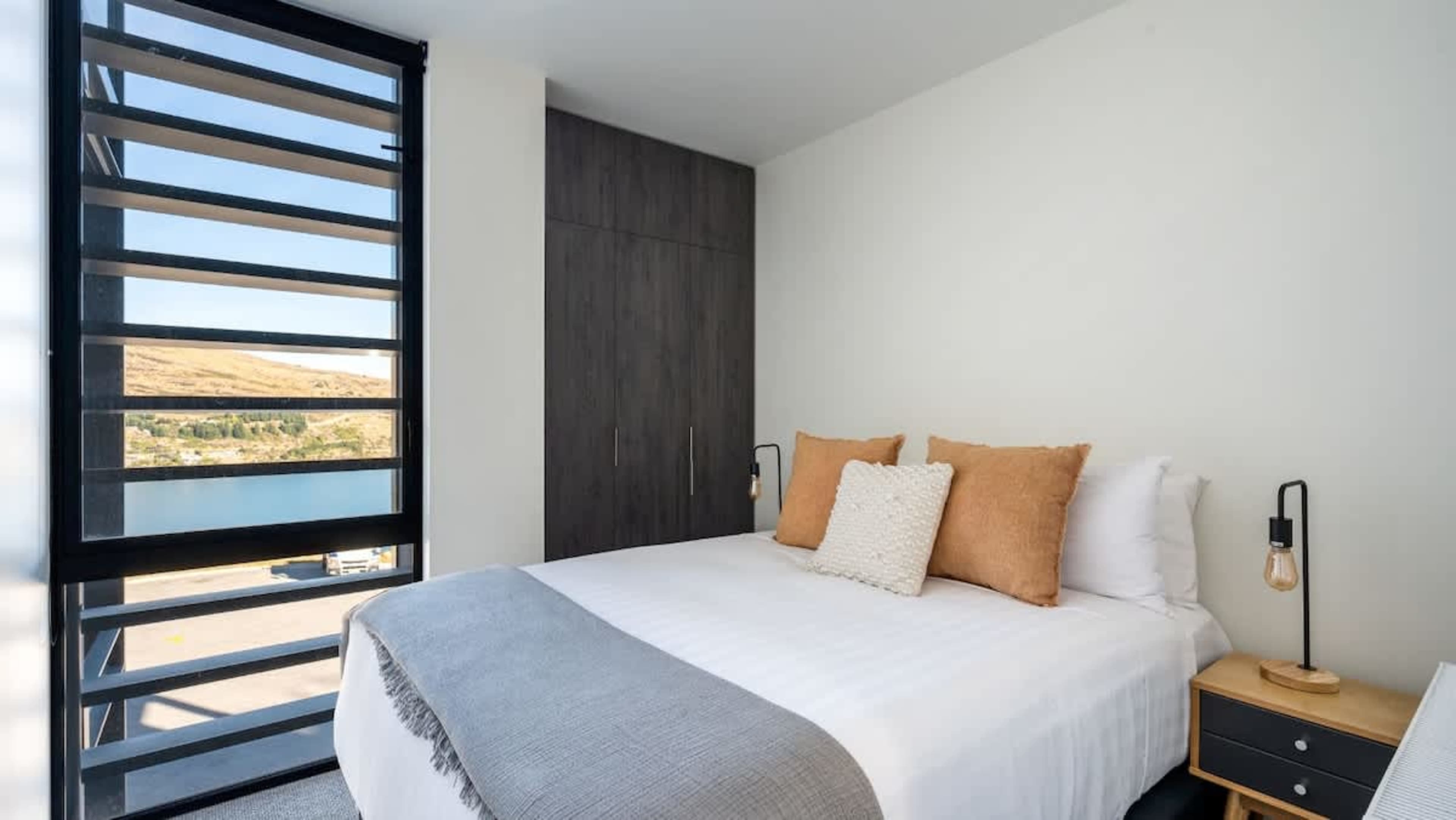 With a cozy queen-sized bed and beautiful views of the lake and mountains, the second bedroom provides a serene escape with a touch of luxury.