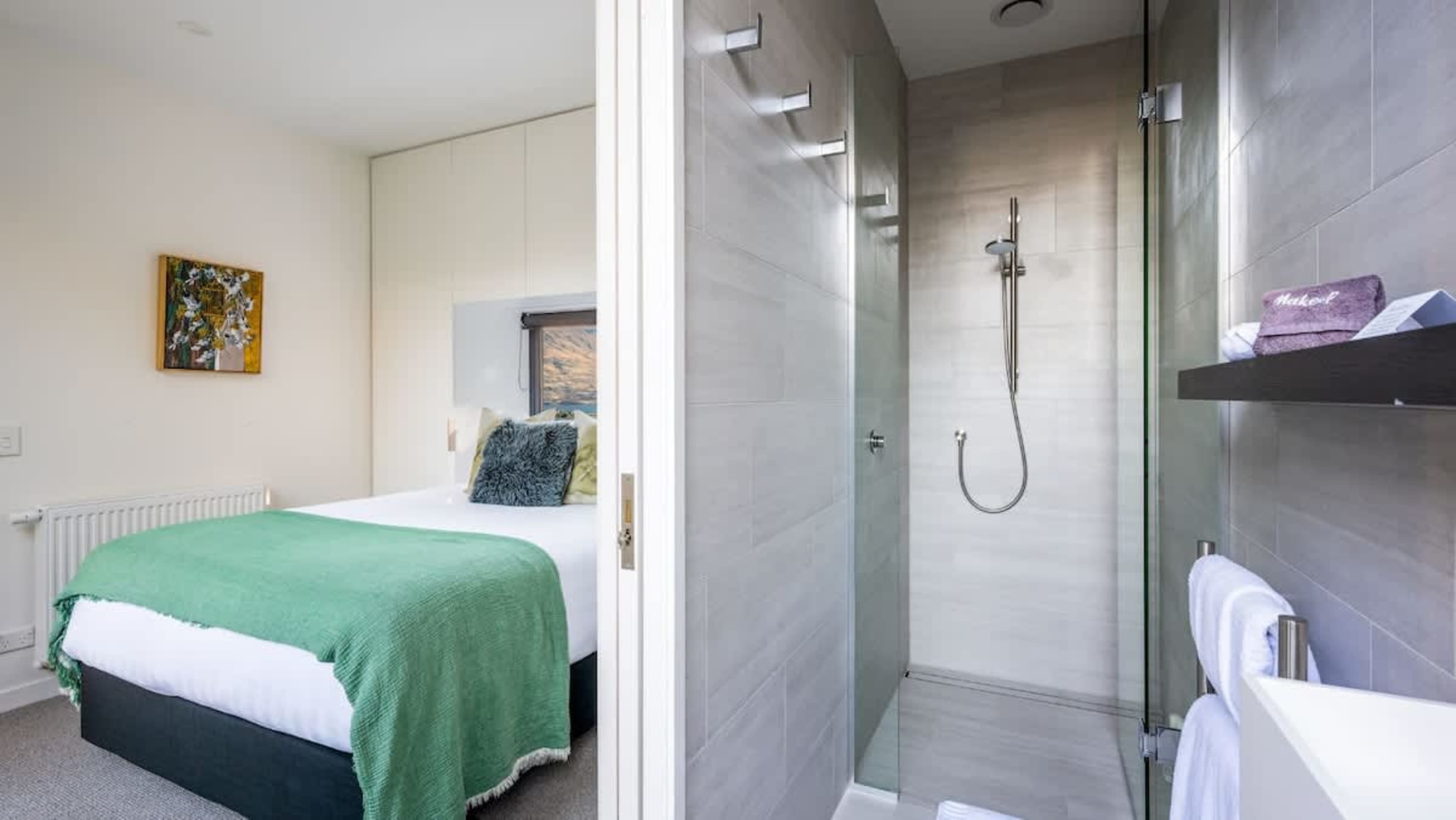 The fourth bedroom boasts a king-sized bed, a private ensuite with sleek finishes, and a tranquil atmosphere, providing a perfect space for rest and rejuvenation.