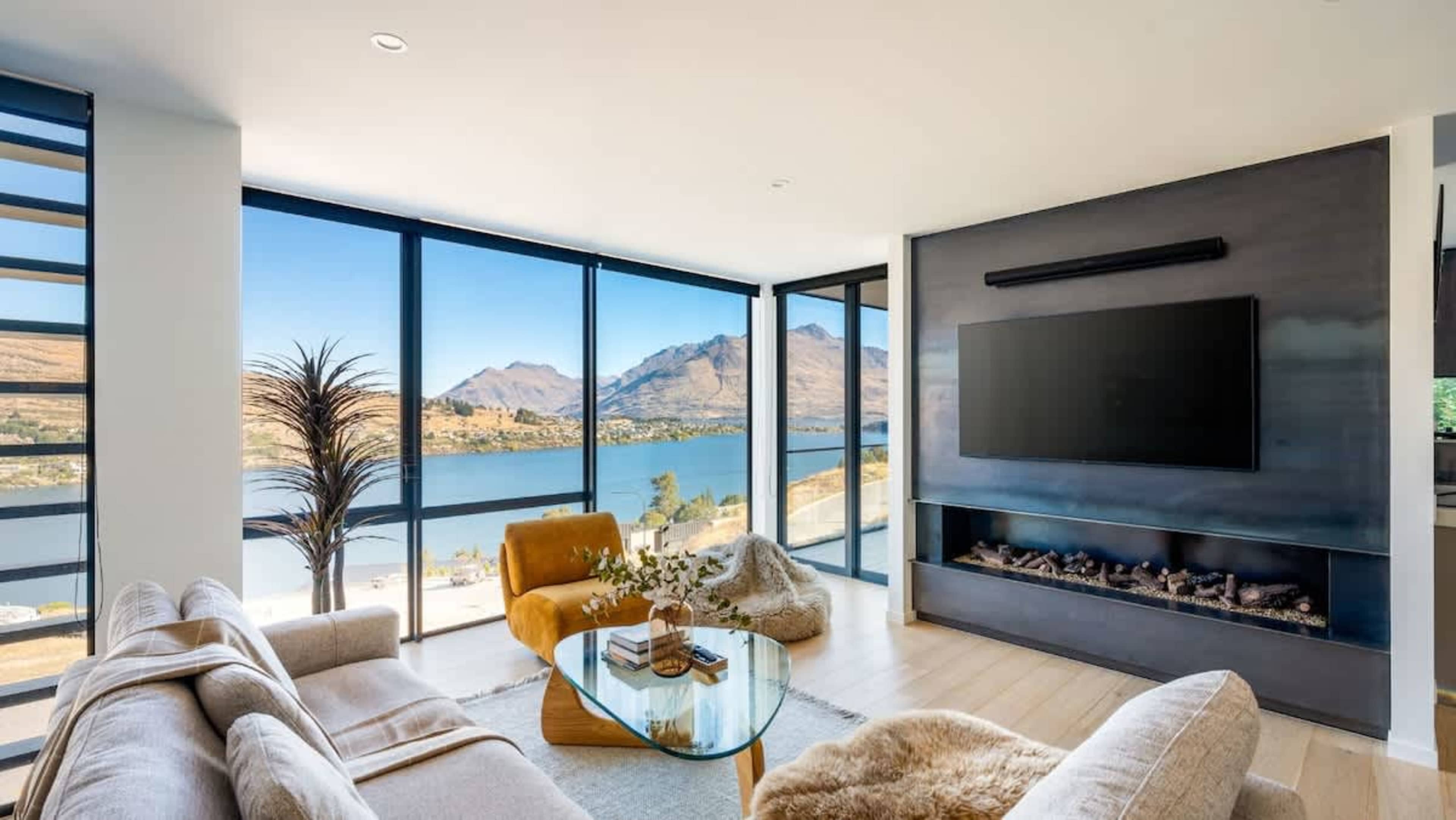 Relax in the expansive living room of this newly built 4-bedroom villa, where you’ll be surrounded by warmth from the indoor fireplace and heated floors, complemented by stunning views of Queenstown’s natural beauty.