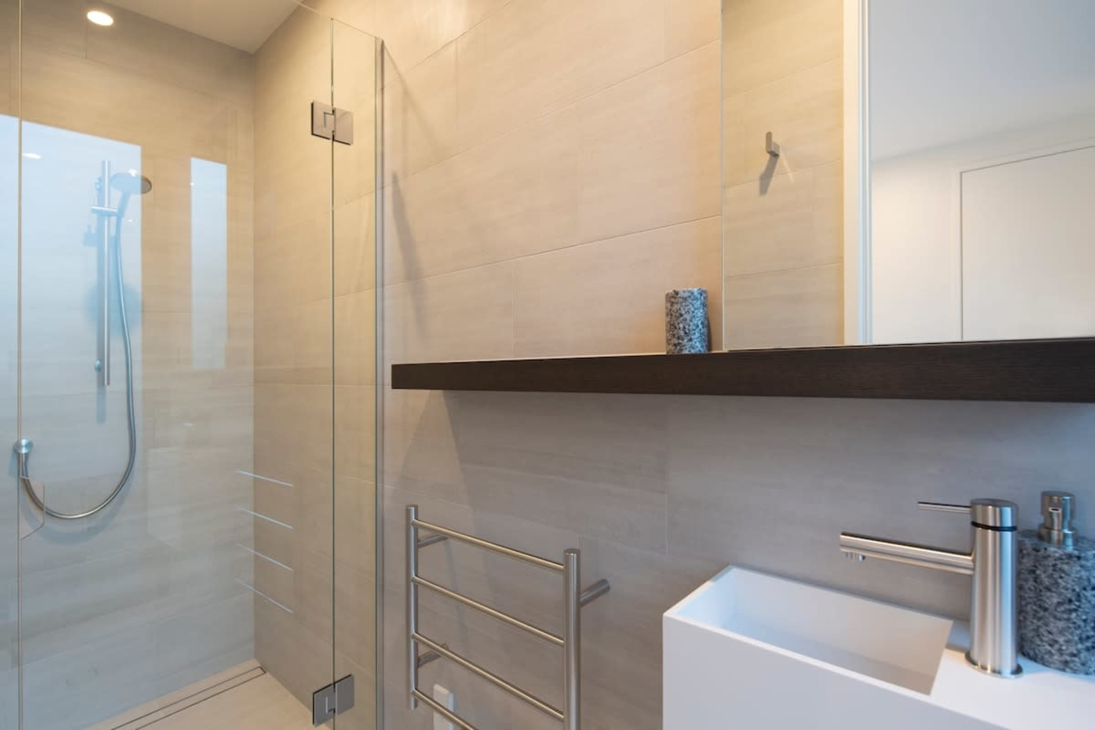 The third bathroom features a contemporary design with a spacious shower, elegant fixtures, and high-quality finishes, providing a comfortable and stylish space.