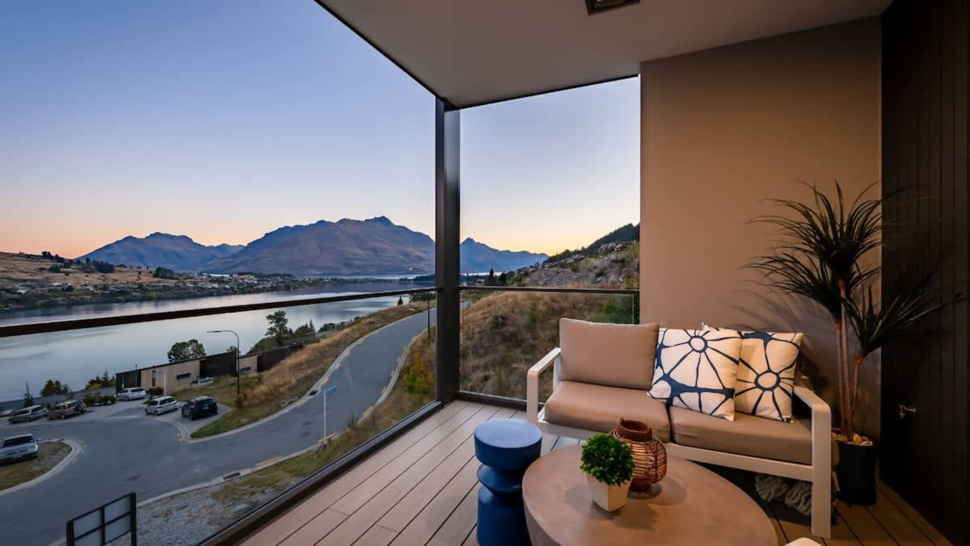 The expansive patio offers stunning lake and mountain views, complete with comfortable seating and space to unwind while soaking in the scenery.
