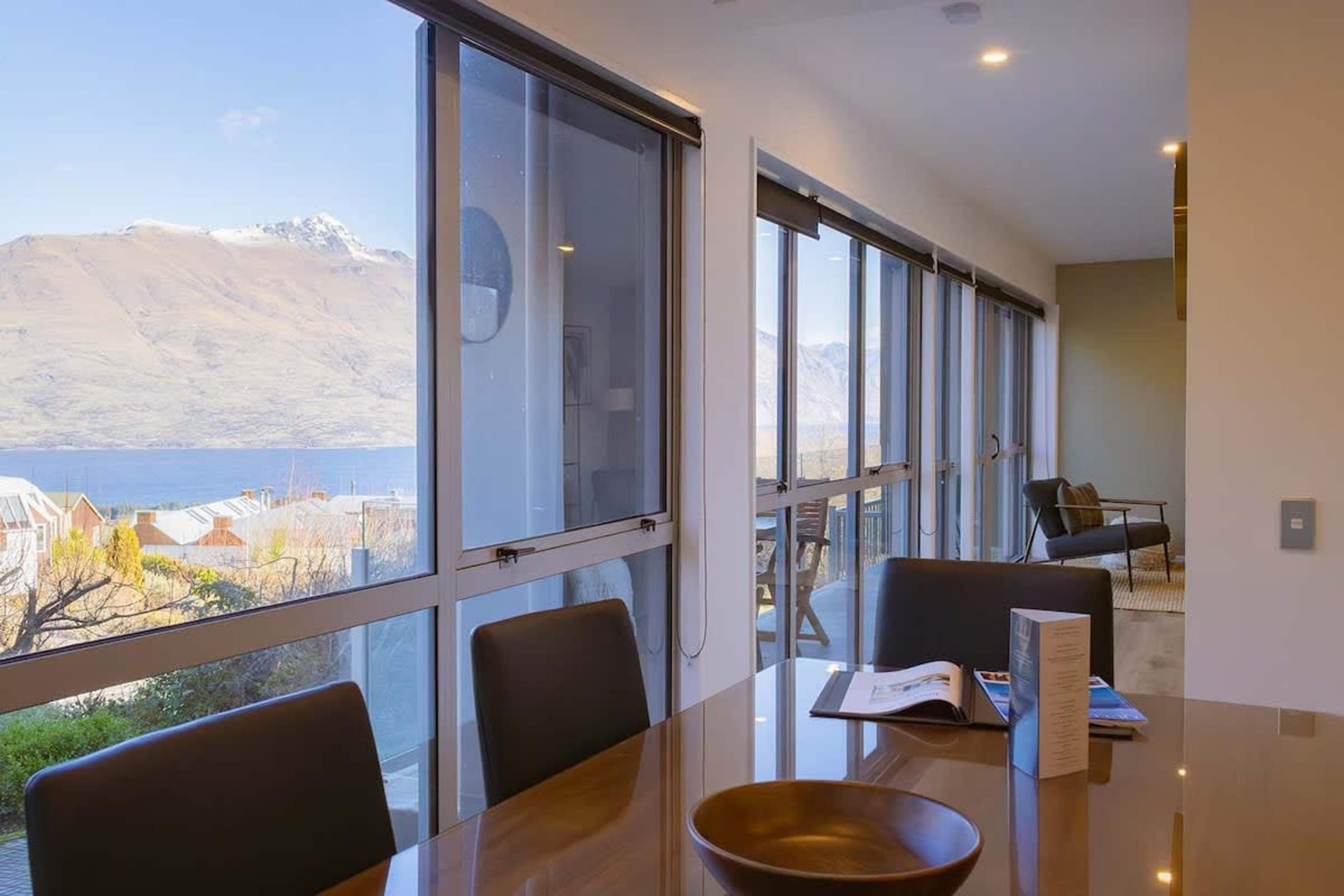 Elegant Dining Area
Enjoy meals in the modern dining room, featuring large windows that frame stunning views of the lake and mountains, with easy access to the patio for outdoor dining with a BBQ.