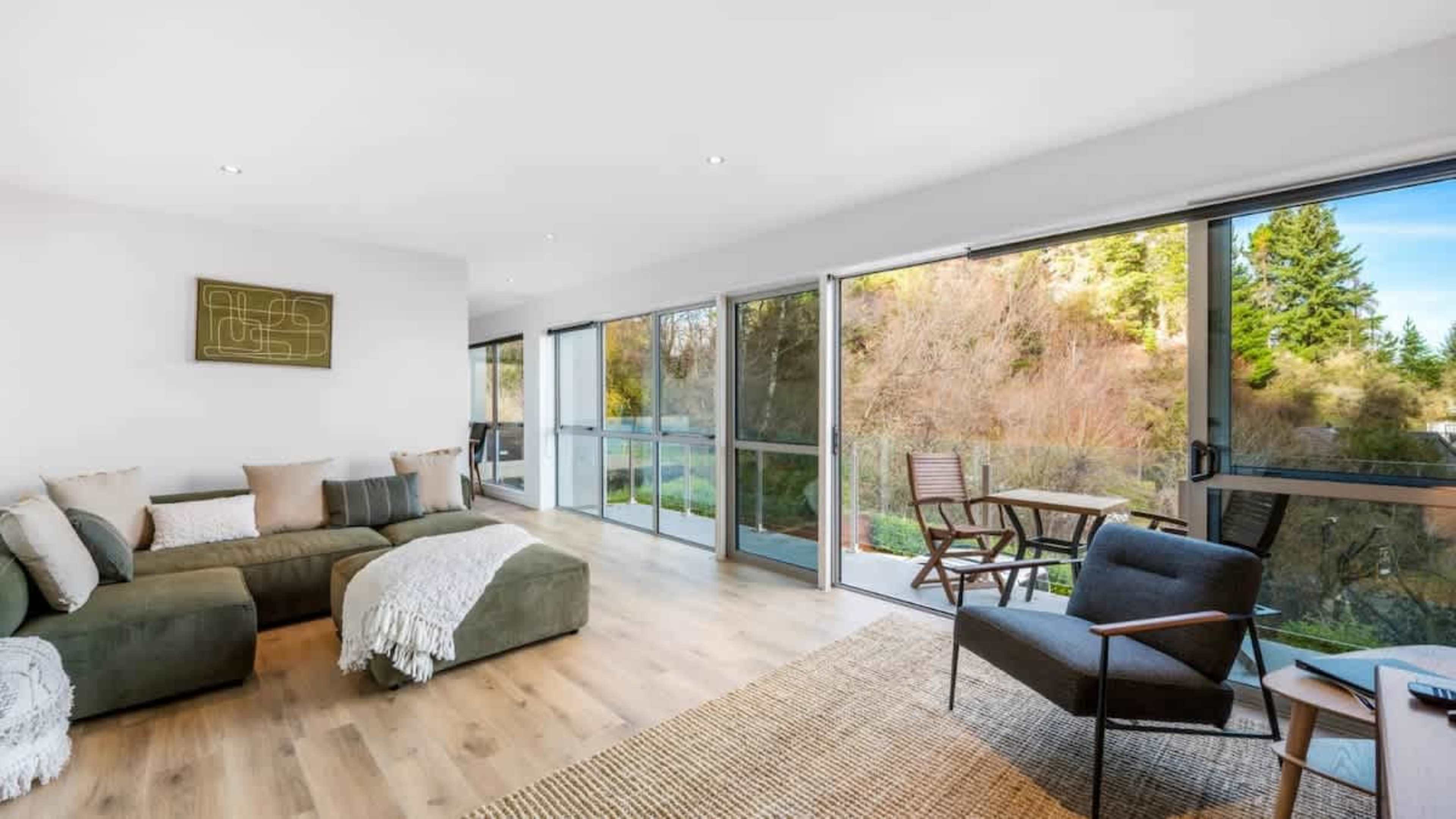 Contemporary Living Room
Unwind in the stylish living room, where large windows frame breathtaking lake and mountain views, just a short drive from Queenstown’s vibrant town center.