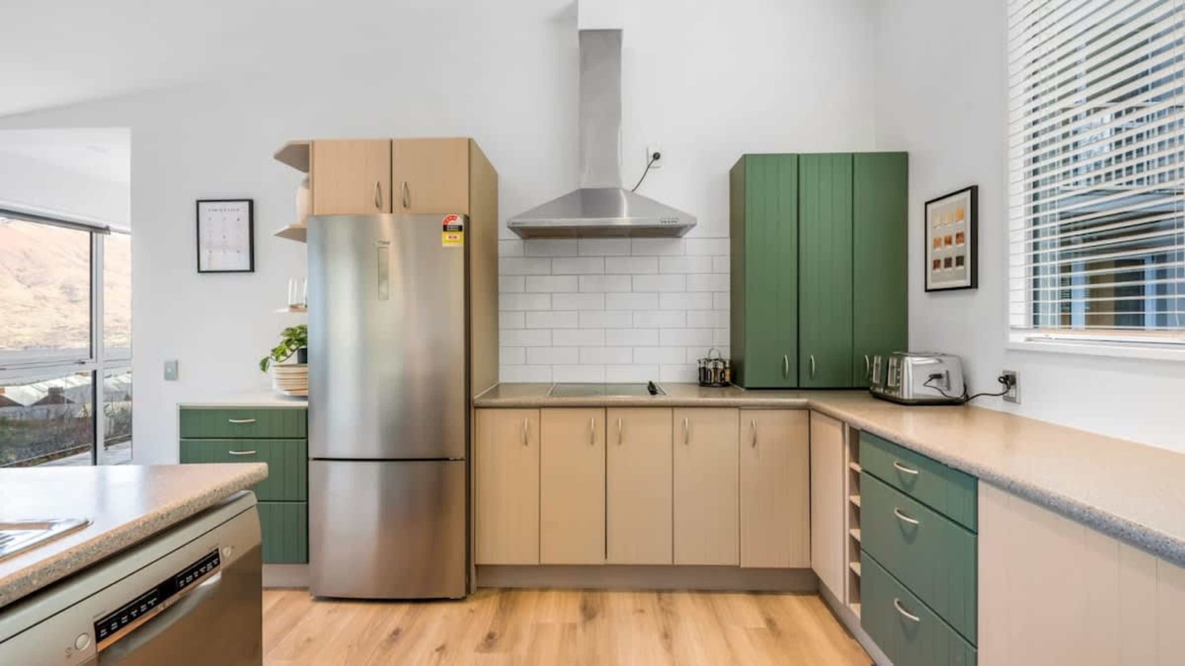 Contemporary Kitchen with Outdoor Access
Cook in style in this sleek kitchen, offering high-end appliances and easy access to the patio with a BBQ, where you can enjoy breathtaking views of the lake and mountains.