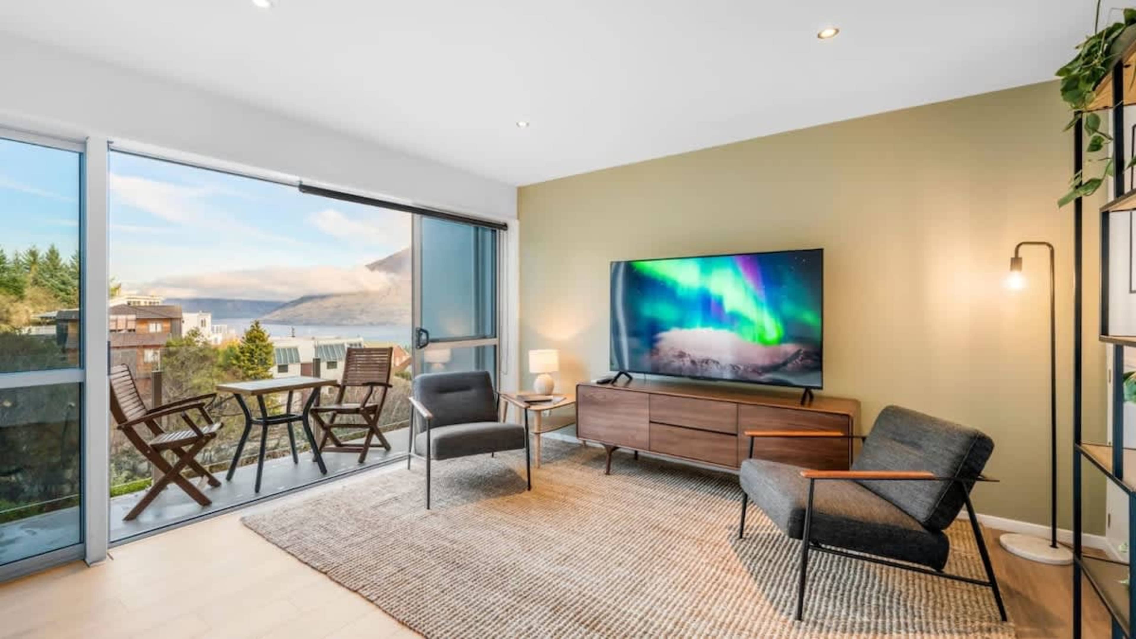 Spacious Living Room with Scenic Views
Relax in the bright and airy living room, offering expansive lake and mountain views, creating a tranquil space just 3-5 minutes from Queenstown.