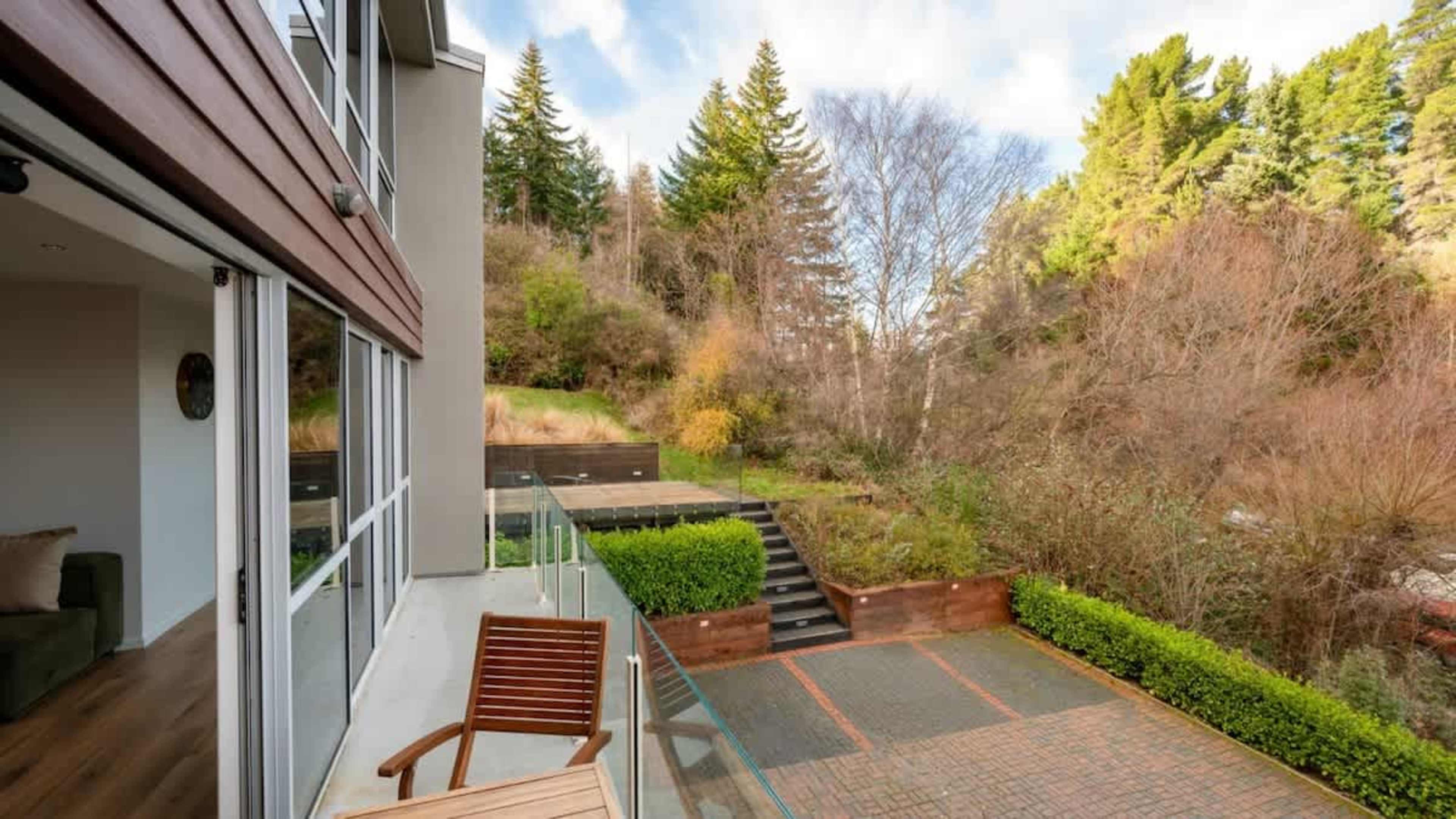 Tranquil Backyard with Nature Views
Unwind in the peaceful backyard, surrounded by lush greenery and the sounds of native birds, offering stunning views of the landscape for a serene escape.