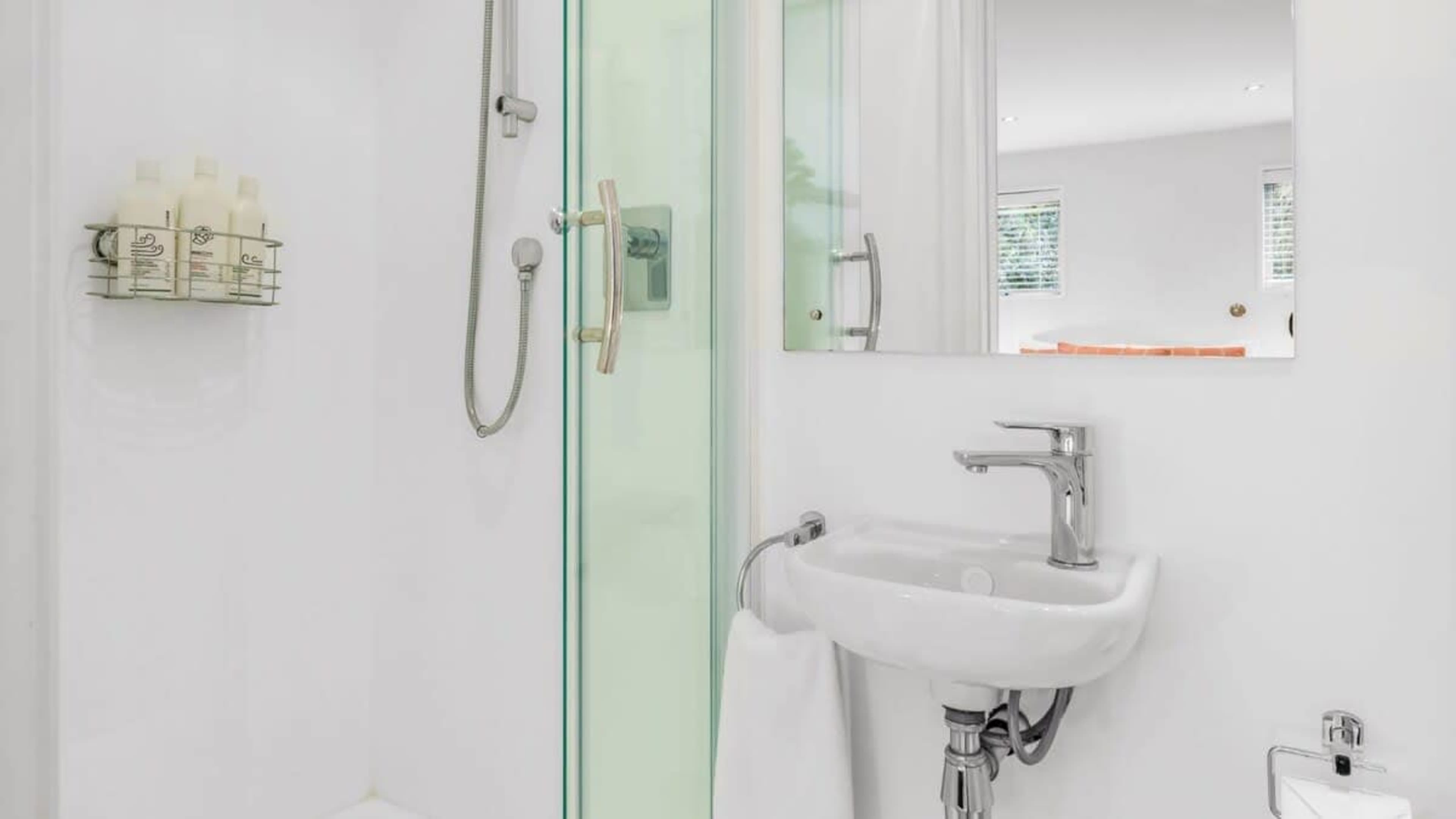 
Stylish Bathroom with Ashley & Co Amenities
Indulge in the elegant bathroom, featuring luxurious Ashley & Co toiletries, offering a spa-like experience with a calming atmosphere and thoughtful touches throughout.