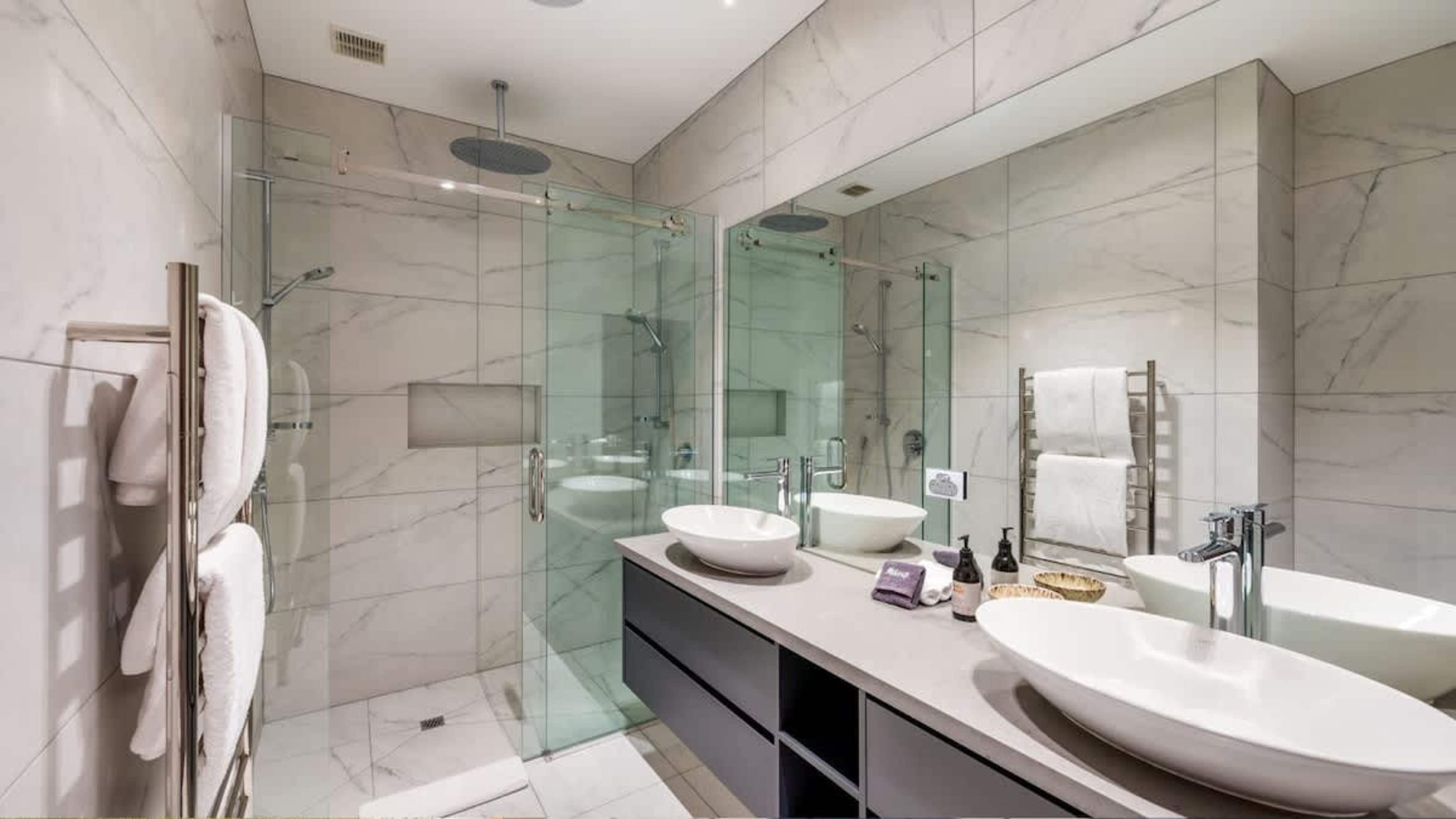 Master Ensuite with His and Her Sinks, Walk-In Showers, Heated Floors, and Ashley & Co Amenities
Indulge in the master ensuite, featuring dual sinks, separate walk-in showers, heated floors for ultimate comfort, and luxurious Ashley & Co toiletries.