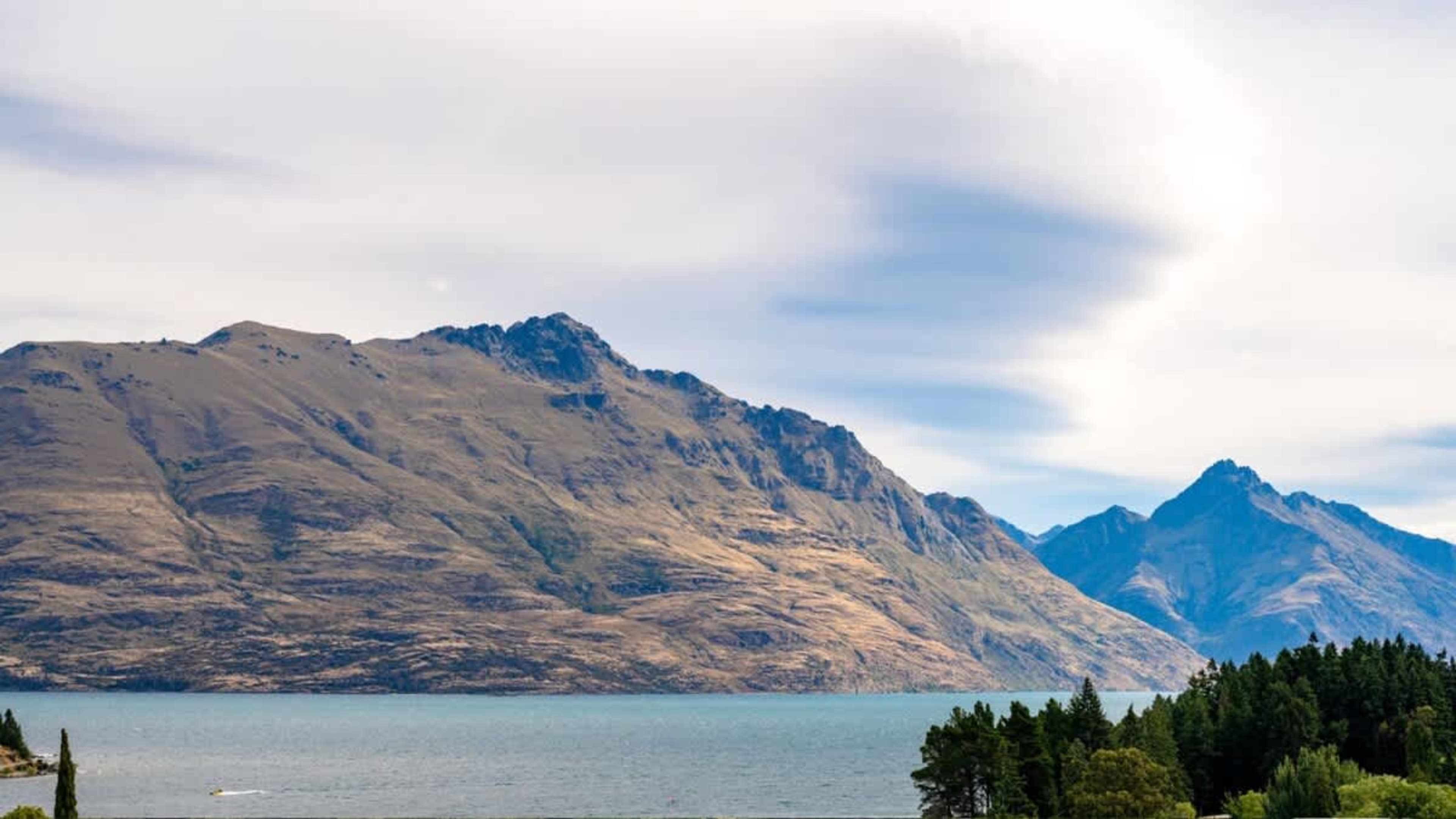 Elevated Balcony with BBQ and Spectacular Views
Take in the panoramic views from the balcony, with a BBQ for outdoor meals and unobstructed vistas of Queenstown CBD, the lake, and mountains.