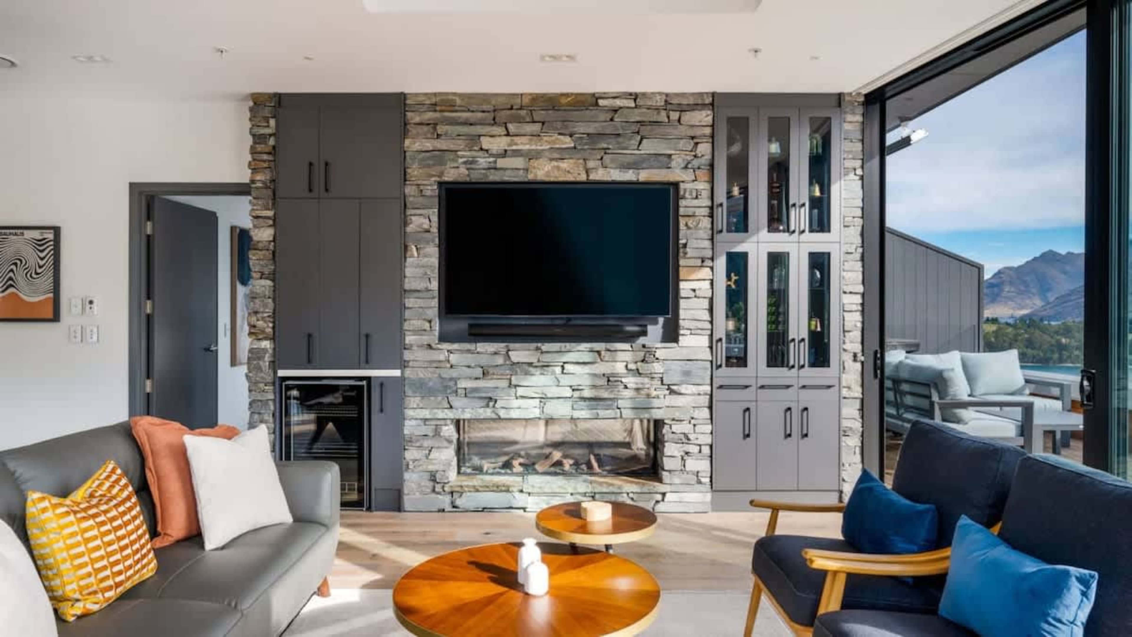 Spacious and Inviting Living Room
Gather in the large living area, designed with a gas fire, AC, and plush seating, all while enjoying the remarkable vistas through the full-length windows.