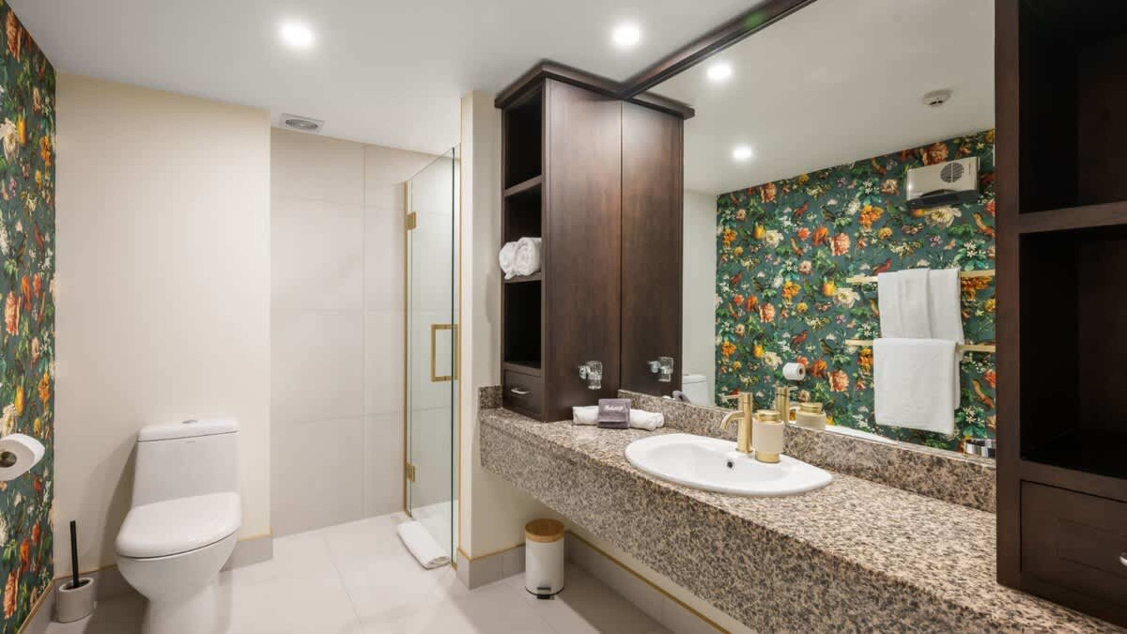 Sleek bathroom with a spacious vanity, soft towels, and luxurious Ashley & Co products to enhance your stay.