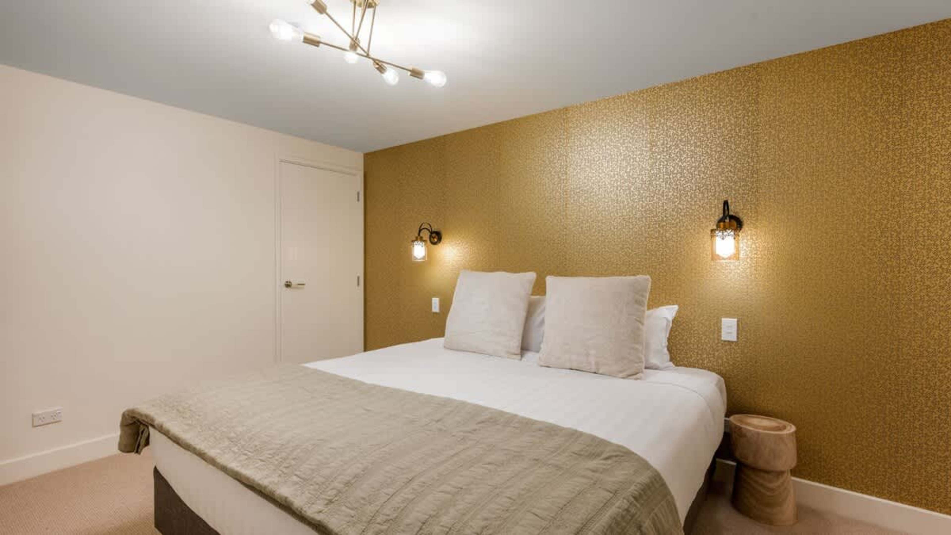 Charming second bedroom featuring a flexible setup, premium bedding, and modern touches for ultimate comfort.