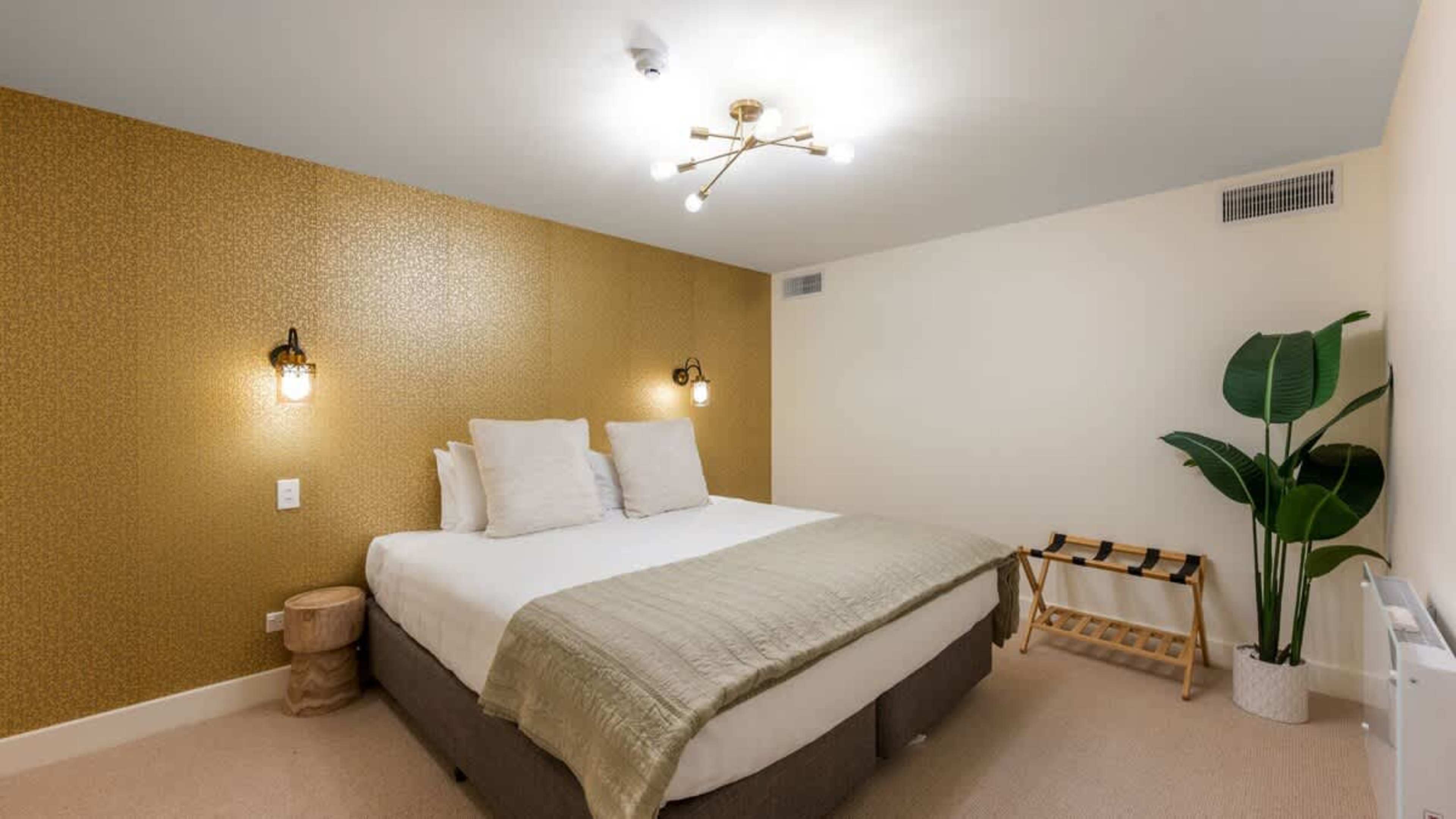 Cozy second bedroom with a comfortable king-sized bed, soft linens, and a serene ambiance for restful nights.
