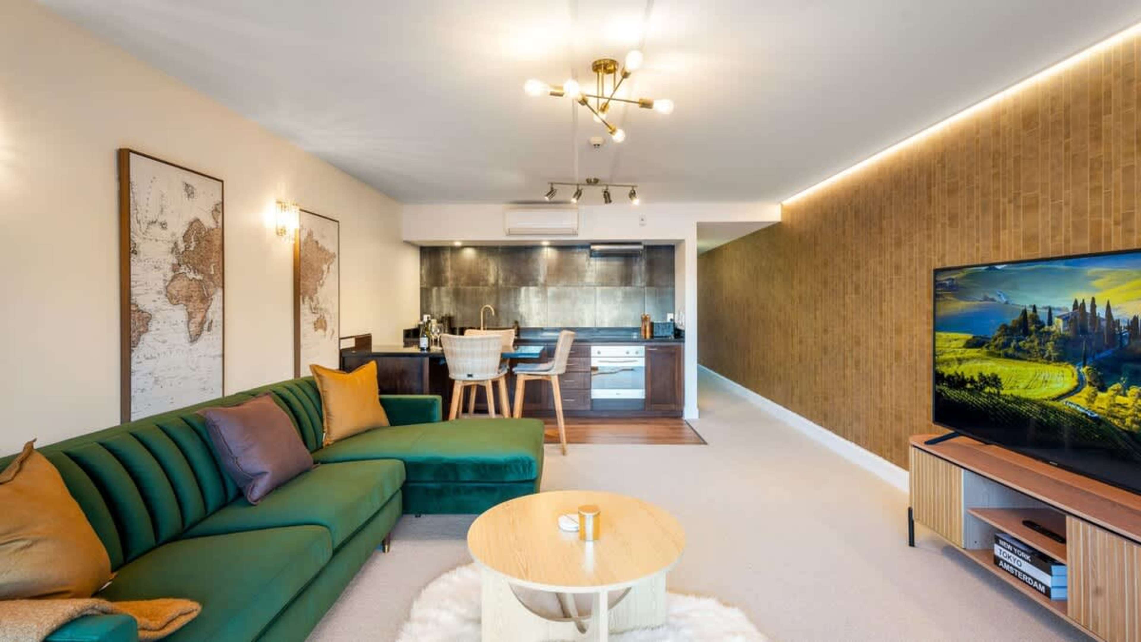 Soak up the Queenstown views from the living room, featuring chic furnishings and an airy, open-plan design.