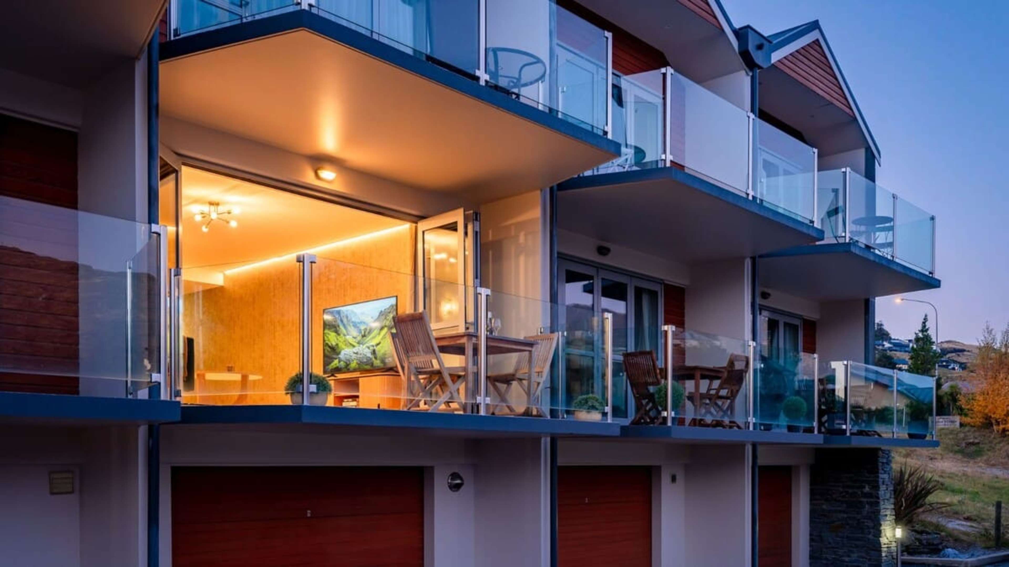 Unwind on the expansive balcony, offering unobstructed views of the lake and mountains, and a perfect spot for outdoor dining or simply enjoying the scenery.