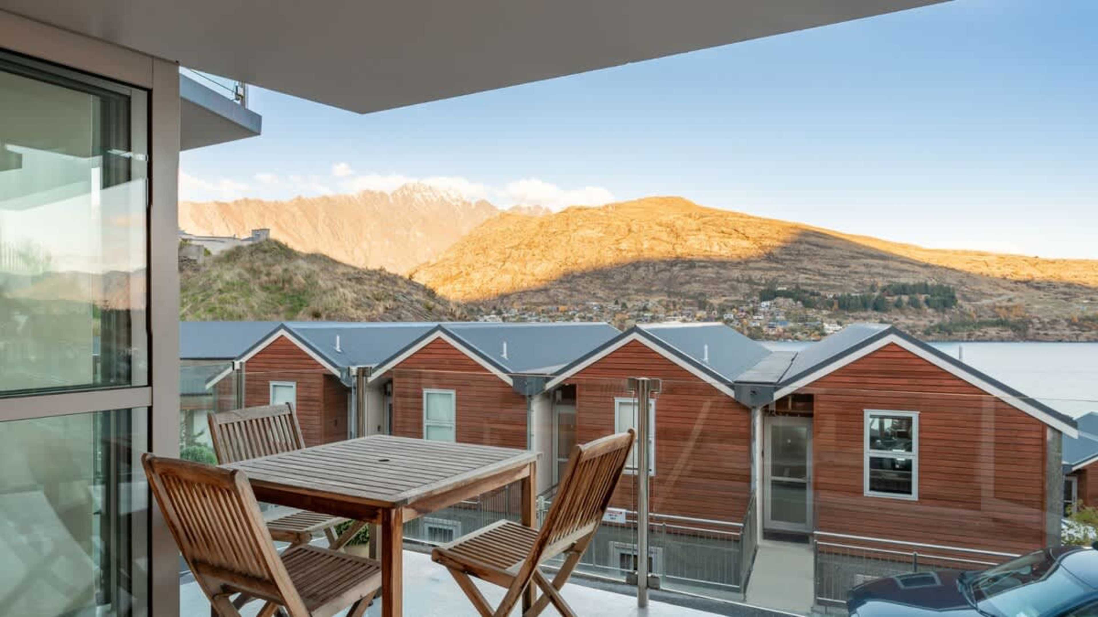 Savor the tranquility of Queenstown from the balcony, featuring stunning views of the lake and mountains, along with a cozy space for outdoor living.
Alpine village - NZ luxury lodges