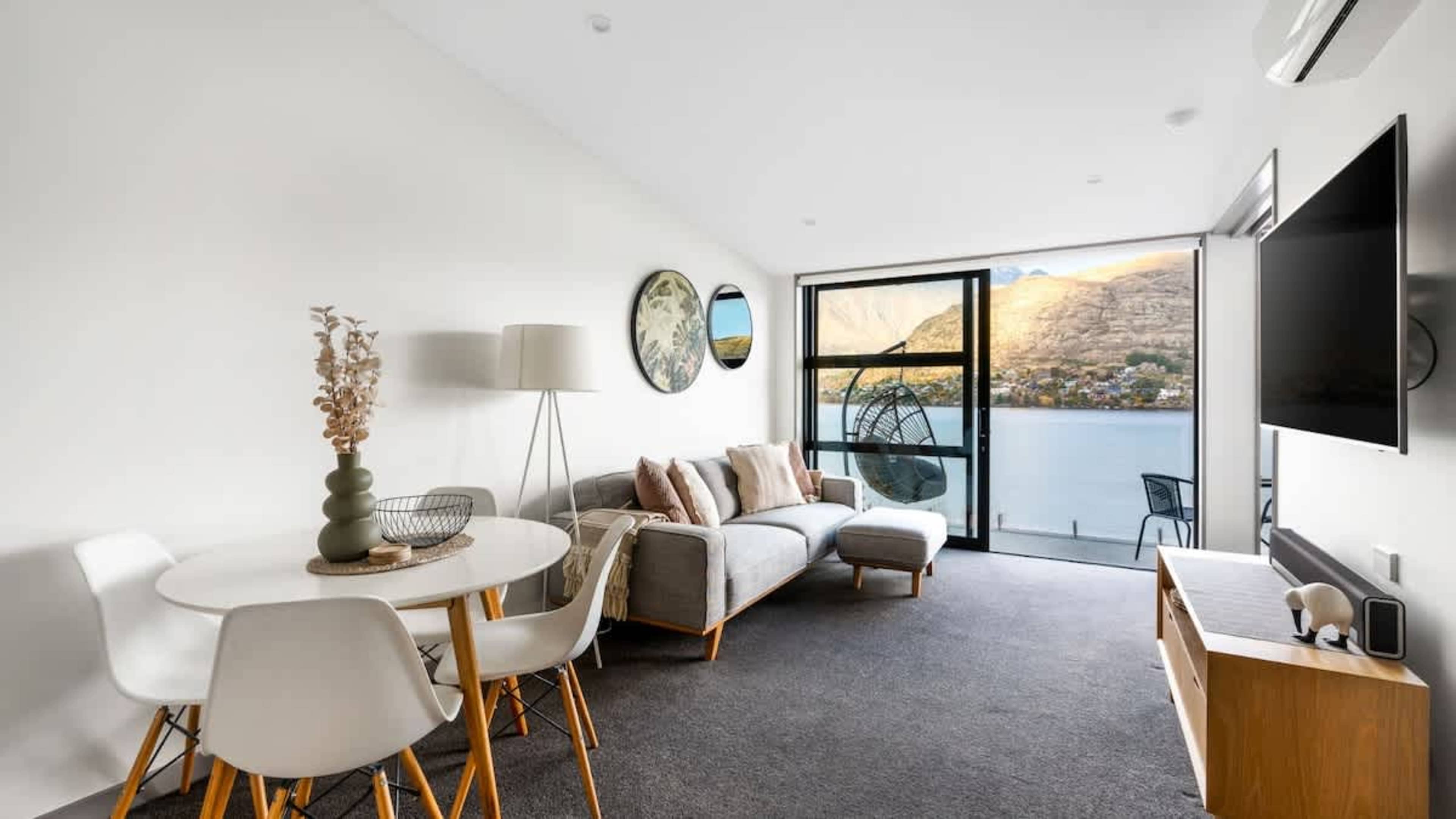 Bright Living Room with Flat-Screen TV and Unforgettable Views – Experience comfort and tranquility in this spacious living room, featuring a flat-screen TV and floor-to-ceiling windows.