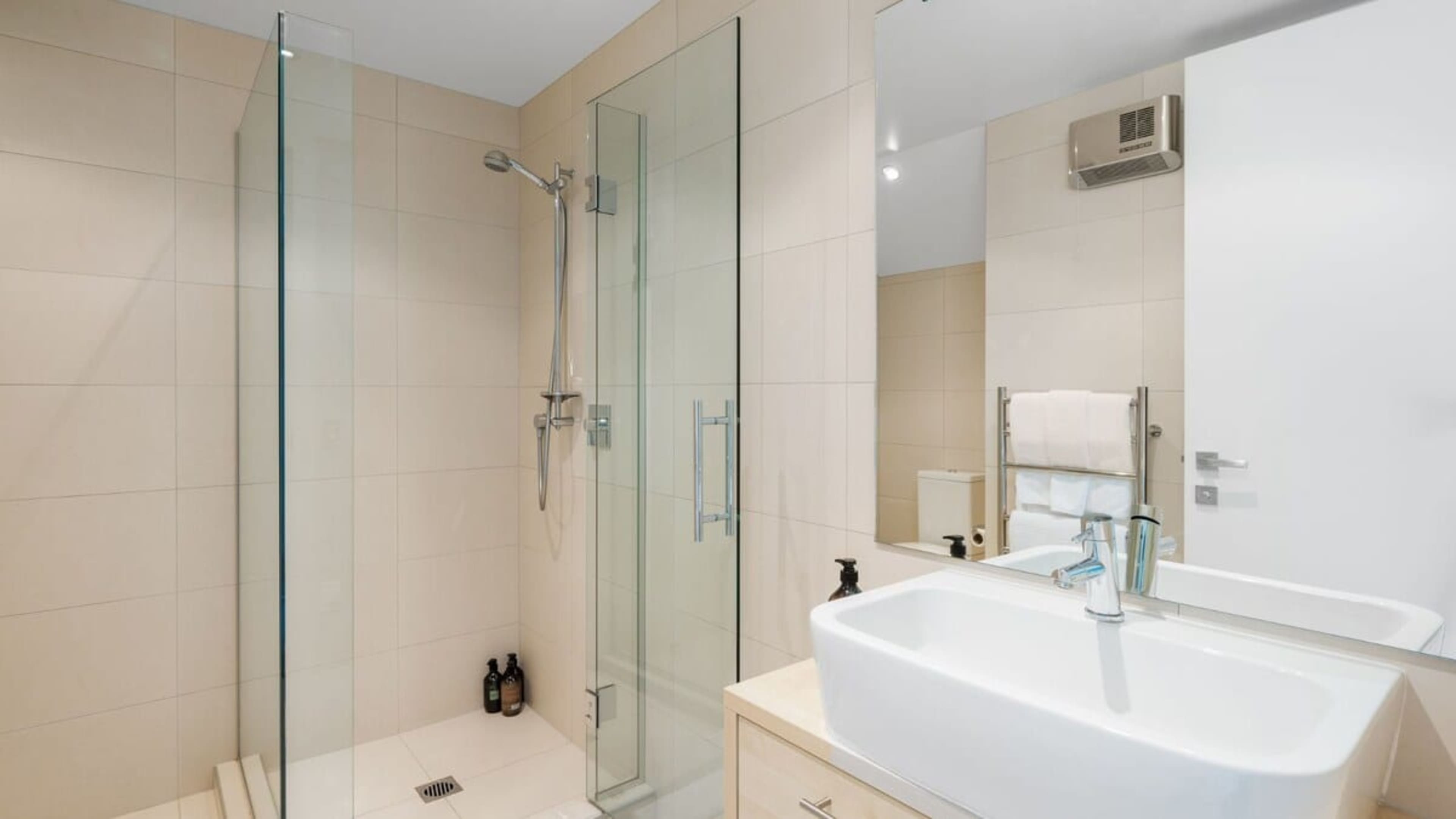 This elegant ensuite bathroom boasts a modern design with high-end finishes and fixtures. Pamper yourself with Ashley and Co toiletries and wrap yourself in soft, premium linen towels, creating a serene and luxurious atmosphere.