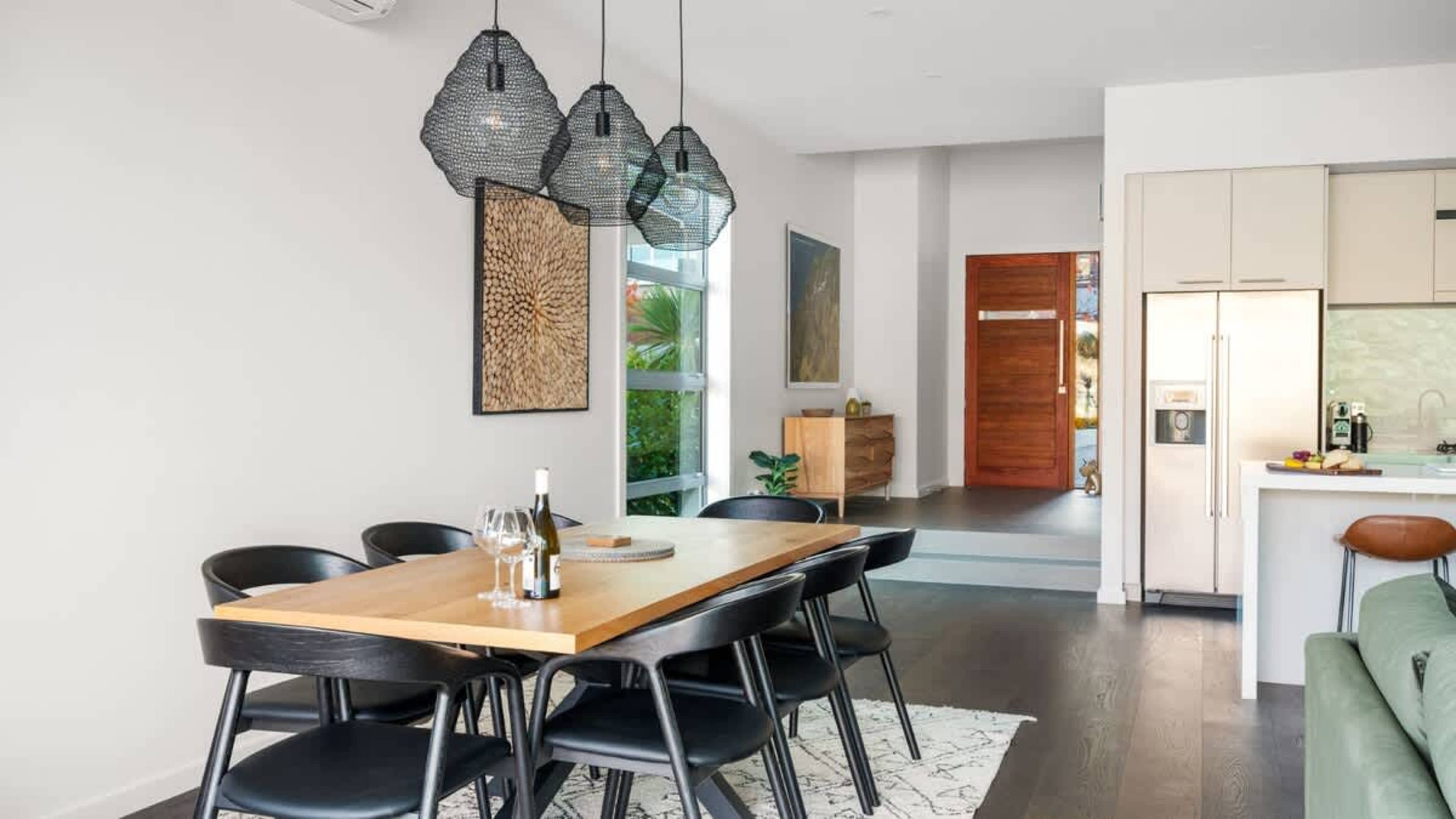 Elegant Dining Room with Patio Access
Enjoy the open-plan dining room, with easy access to the patio, where a dining table awaits, offering breathtaking views of the surrounding landscape.