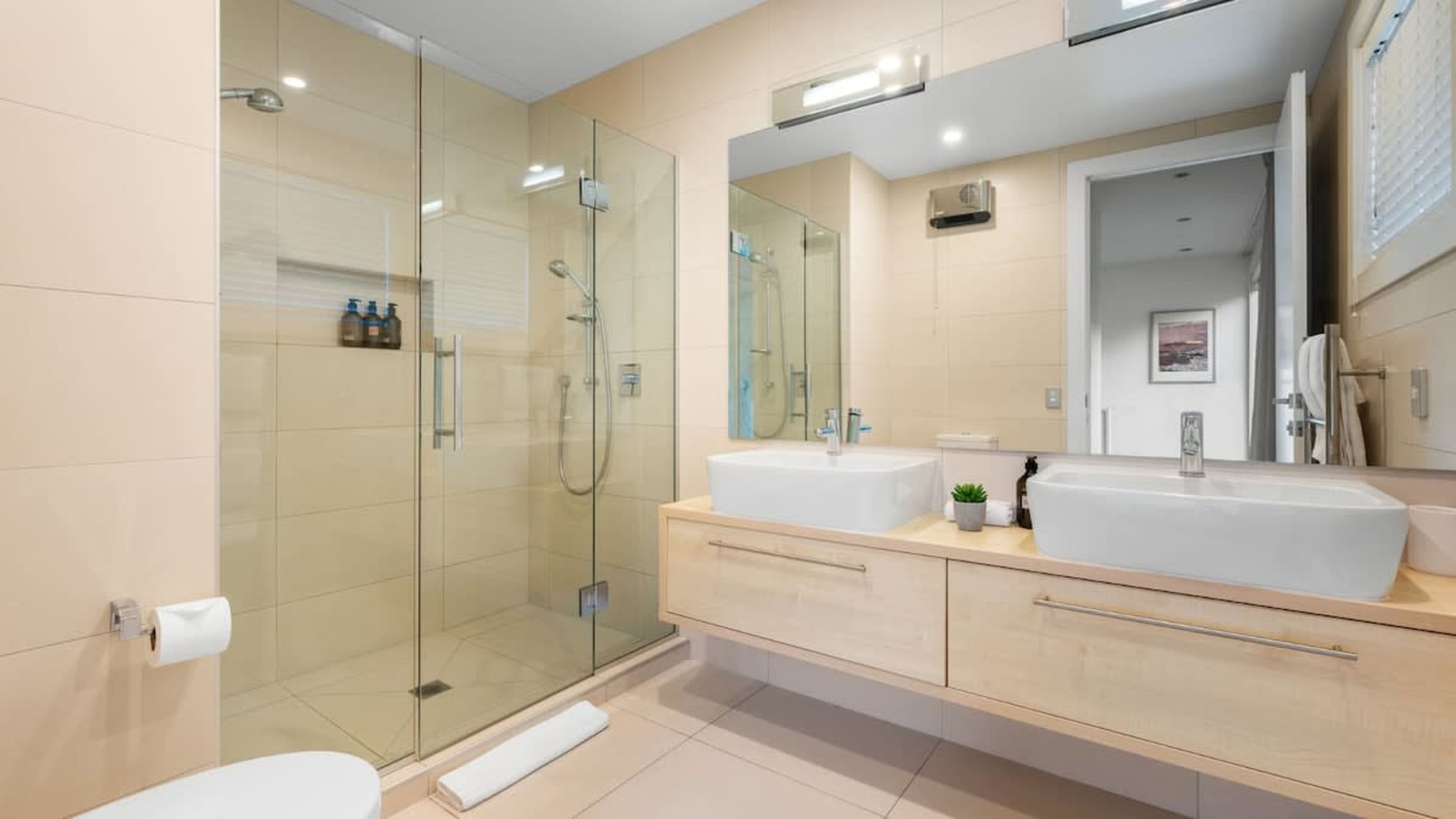 Master Ensuite with Heated Floors and Ashley & Co Amenities
Indulge in the master ensuite, featuring heated floors, a walk-in shower, and luxurious Ashley & Co toiletries, offering a spa-like experience for ultimate relaxation.