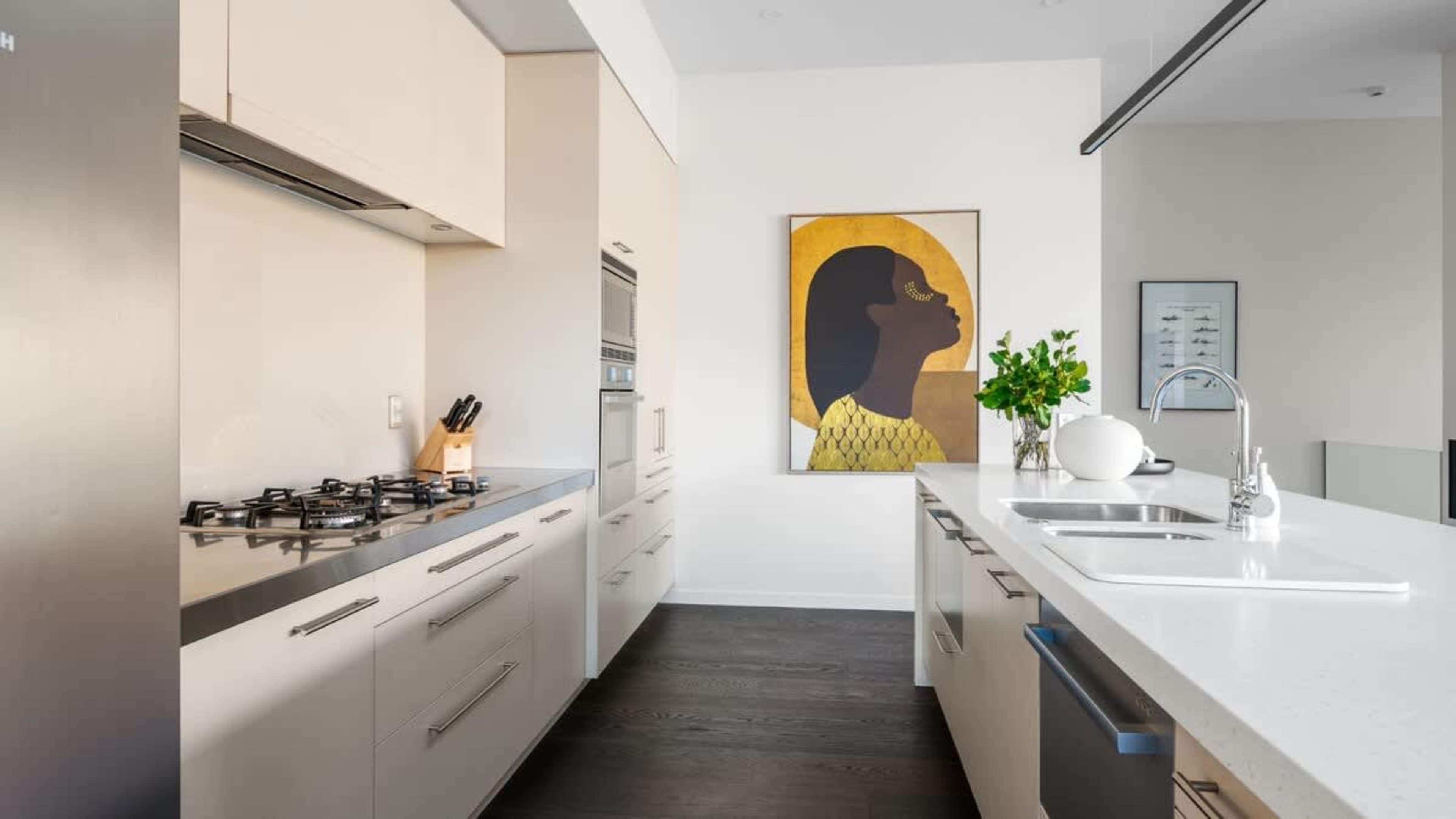 Fully Equipped Kitchen with Views
Experience the ultimate in convenience and style with the fully equipped kitchen, featuring high-end appliances, a Nespresso machine, and large windows offering scenic views.