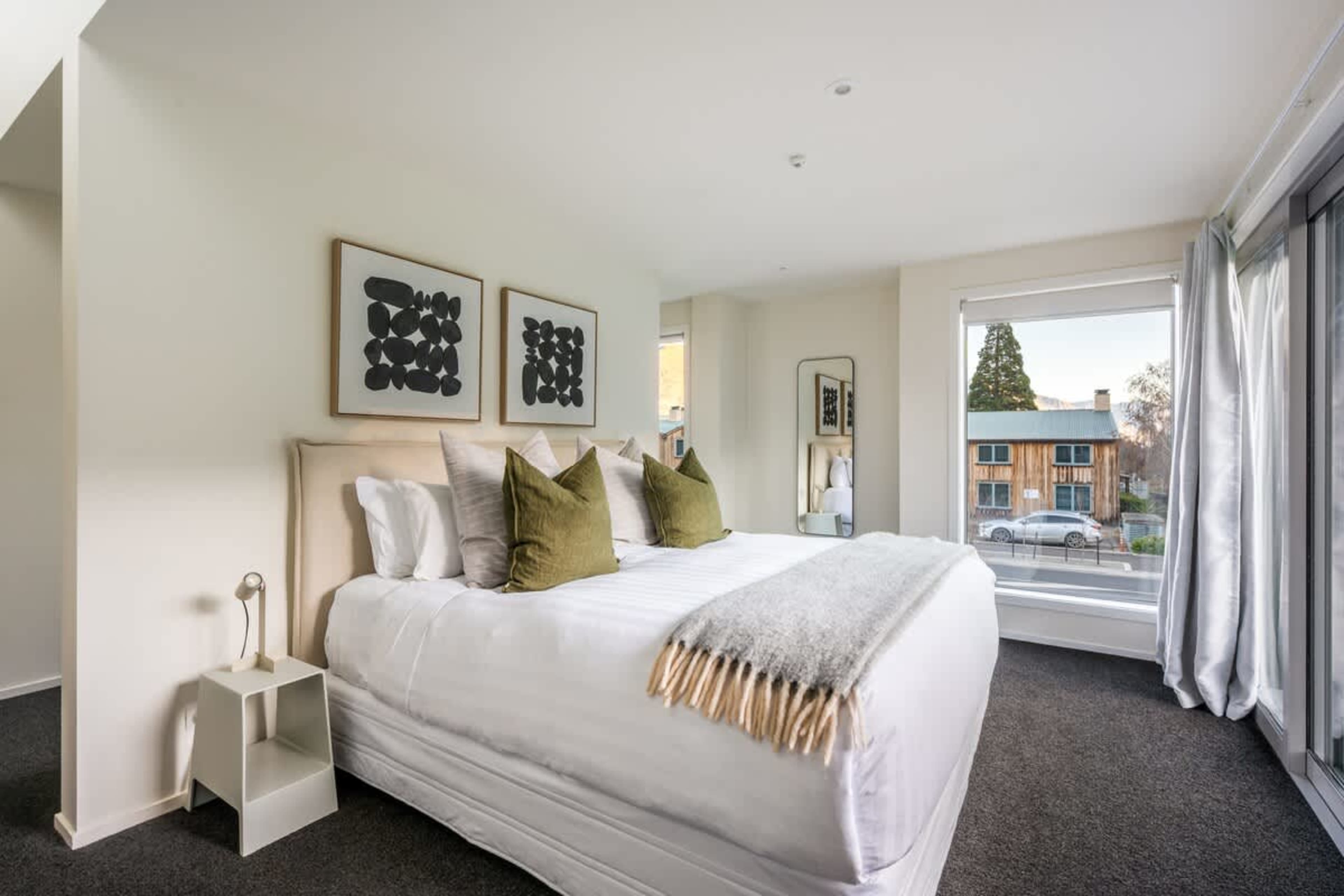 Relax in the Spacious Master Bedroom with Private Patio
Step into this luxurious master bedroom, featuring a comfortable bed and direct access to a private patio. Perfect for unwinding after a day in Queenstown