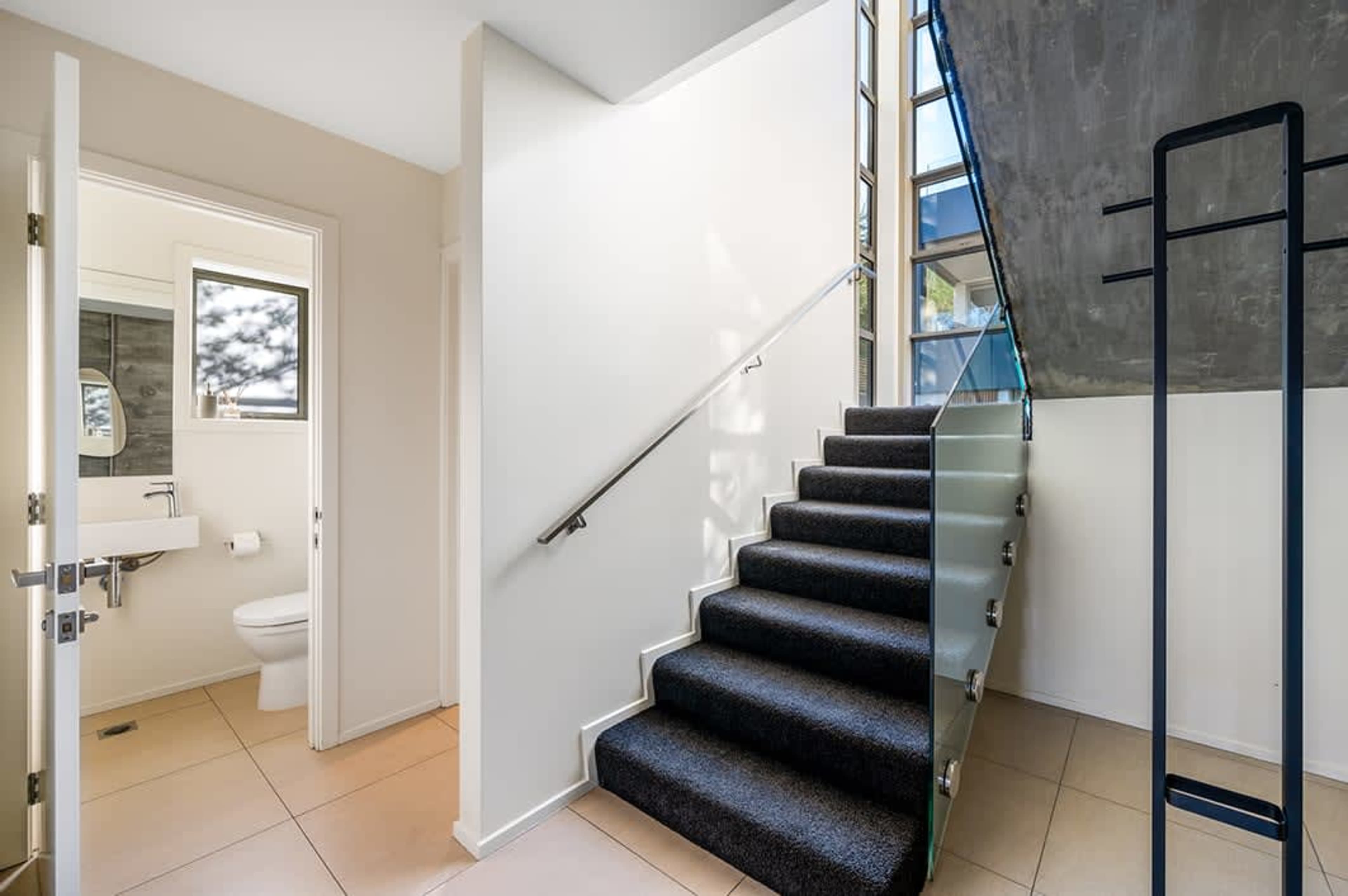 Convenient Half Bathroom
This stylish half bathroom features modern fixtures and a sleek design, perfect for quick visits. Ideal for guests and easily accessible from the main living areas.